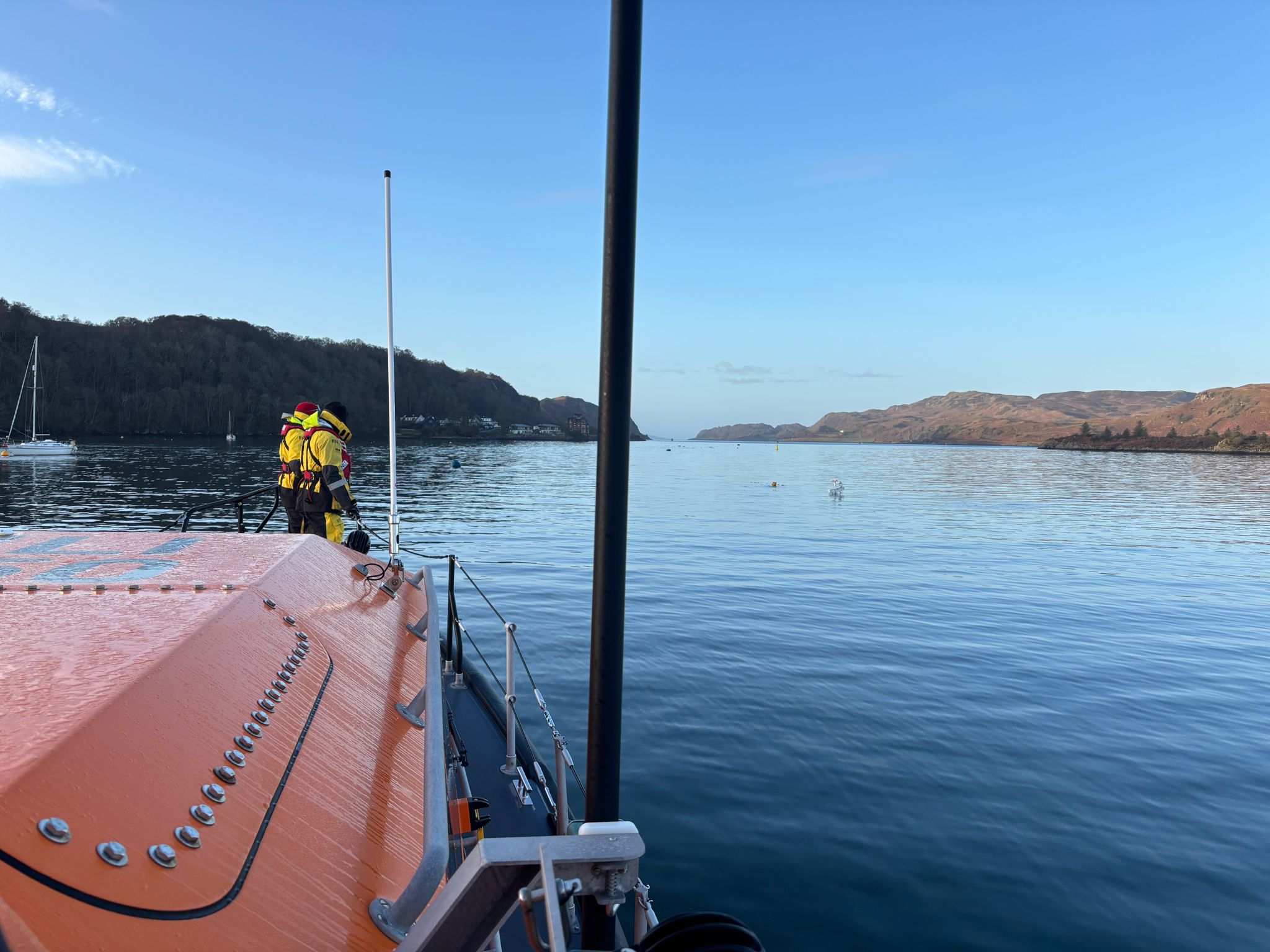 The lifeboat stands off with just the top of the mast of the sunken vessel visible