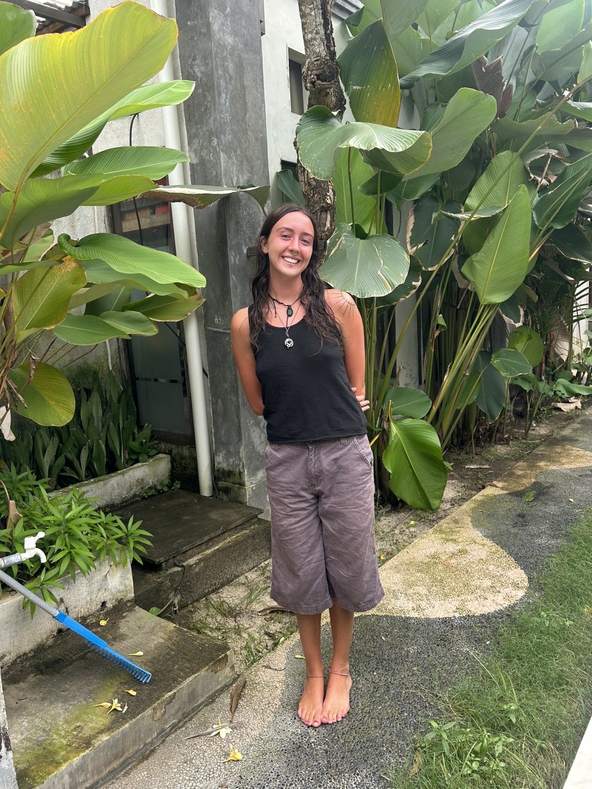 Portrait image of Freya with plants behind 
