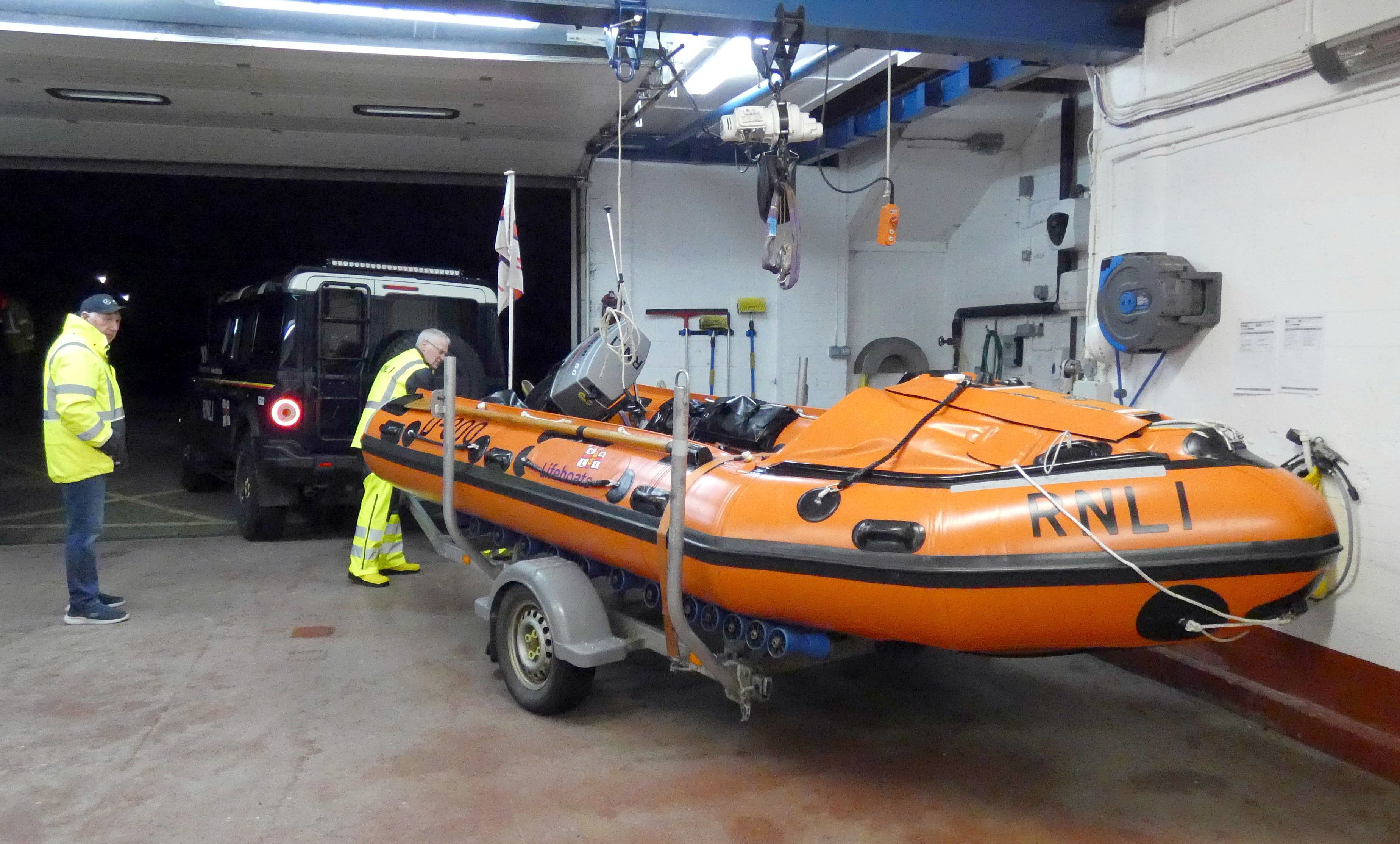 Two men check an inshore lifeboat