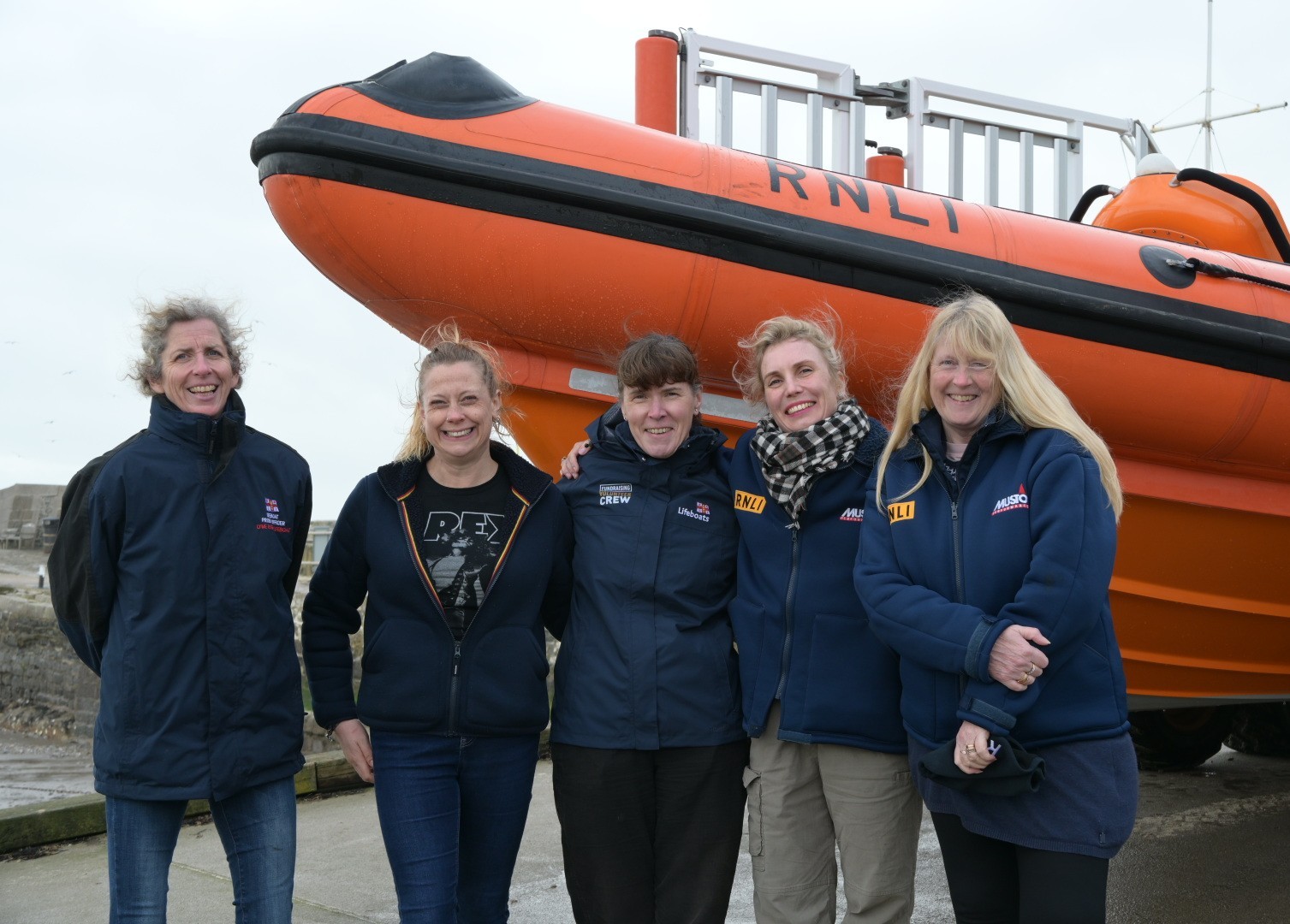 Group of five women front of inshore lifeboat