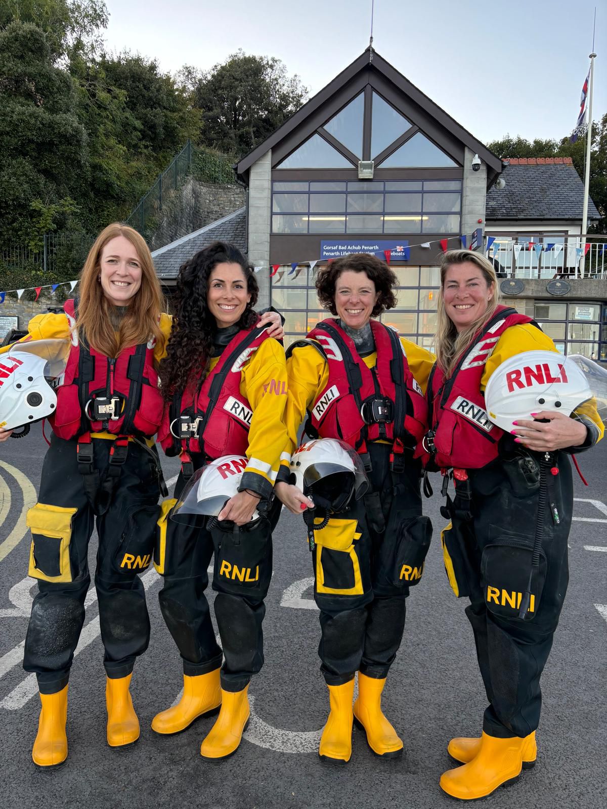 Liv, Nicky, Alisha and Kath standing in kit outside Penarth RNLI Lifeboat Station