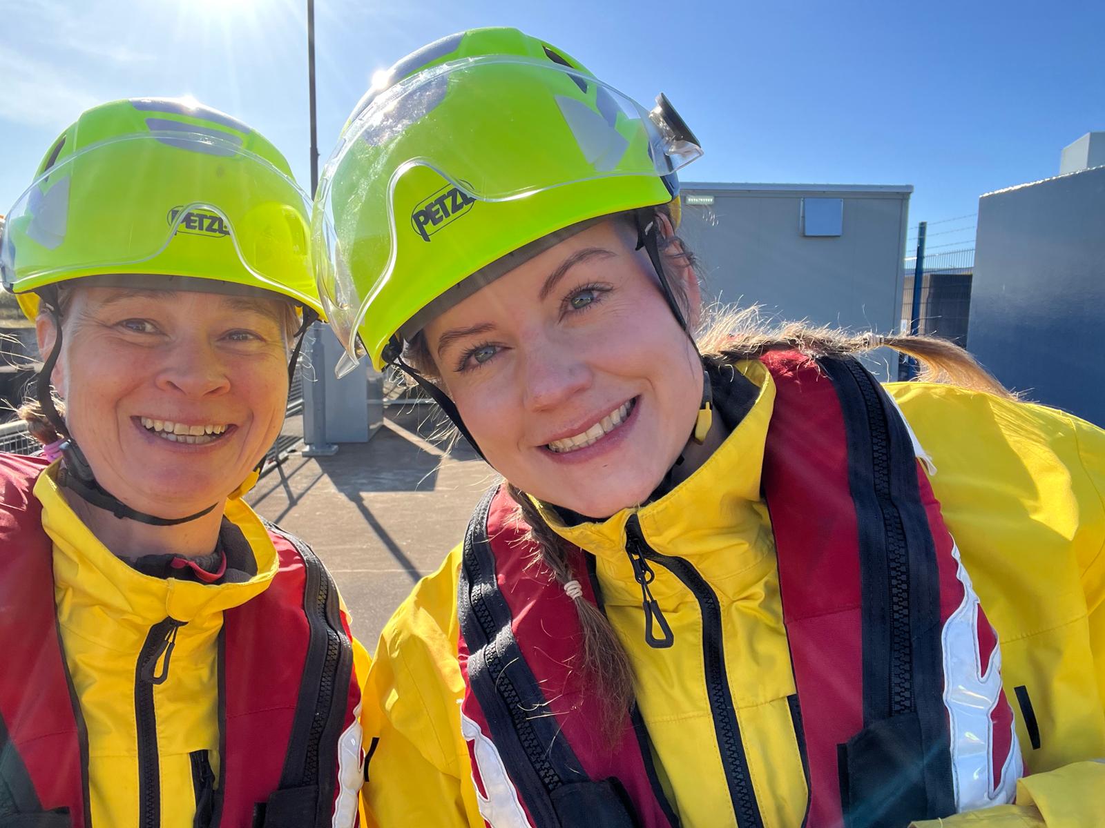 Two women in lifeboat gear.