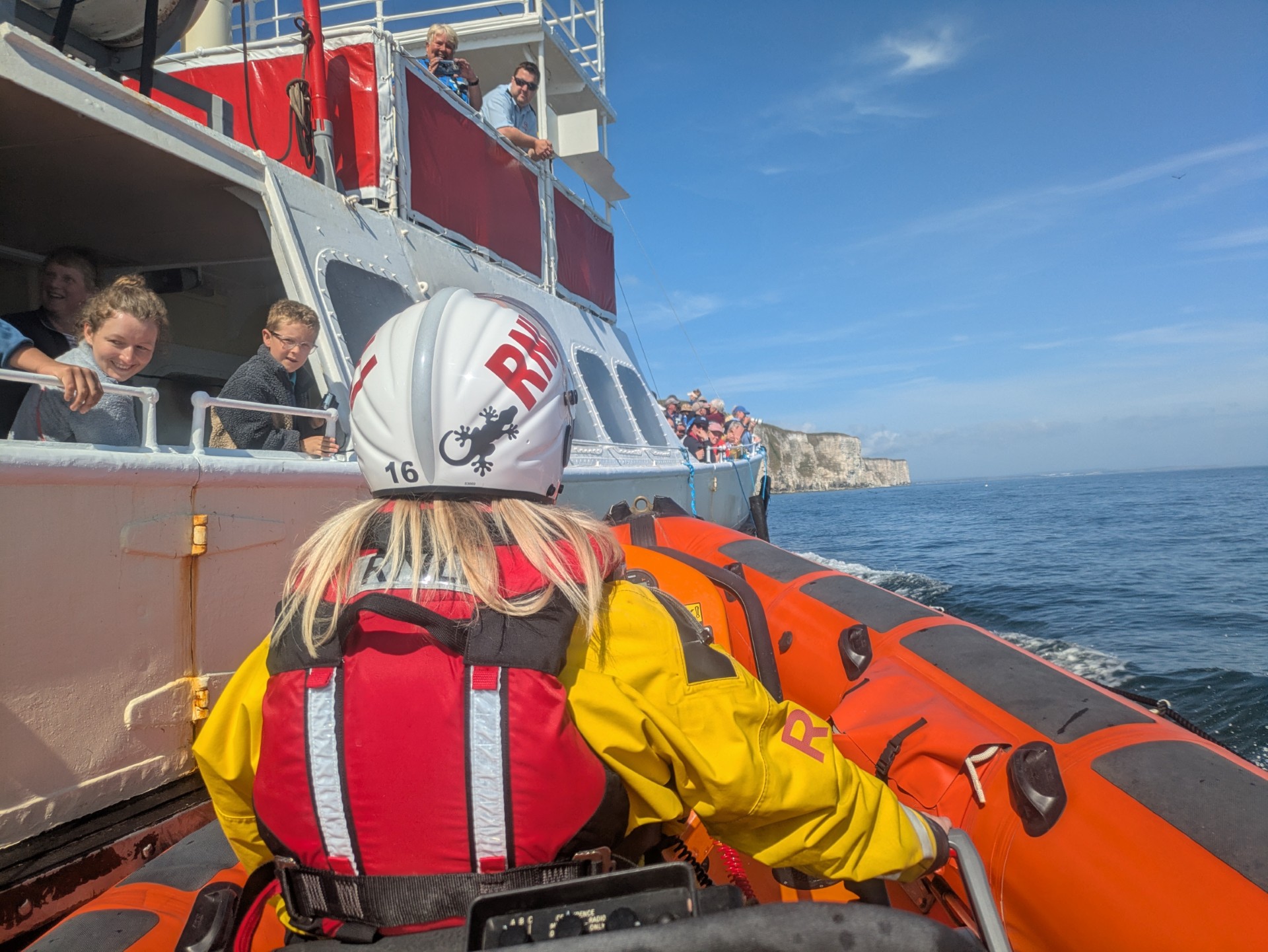 Adria at the helm manoeuvring near a pleasure boat whilst on exerciseise