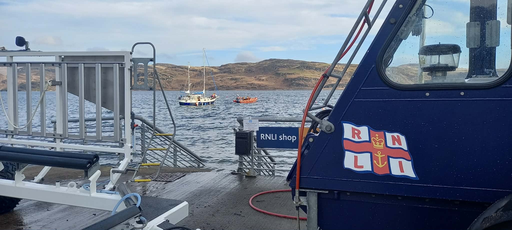 The lifeboat tows the yacht to a mooring in sight of the station