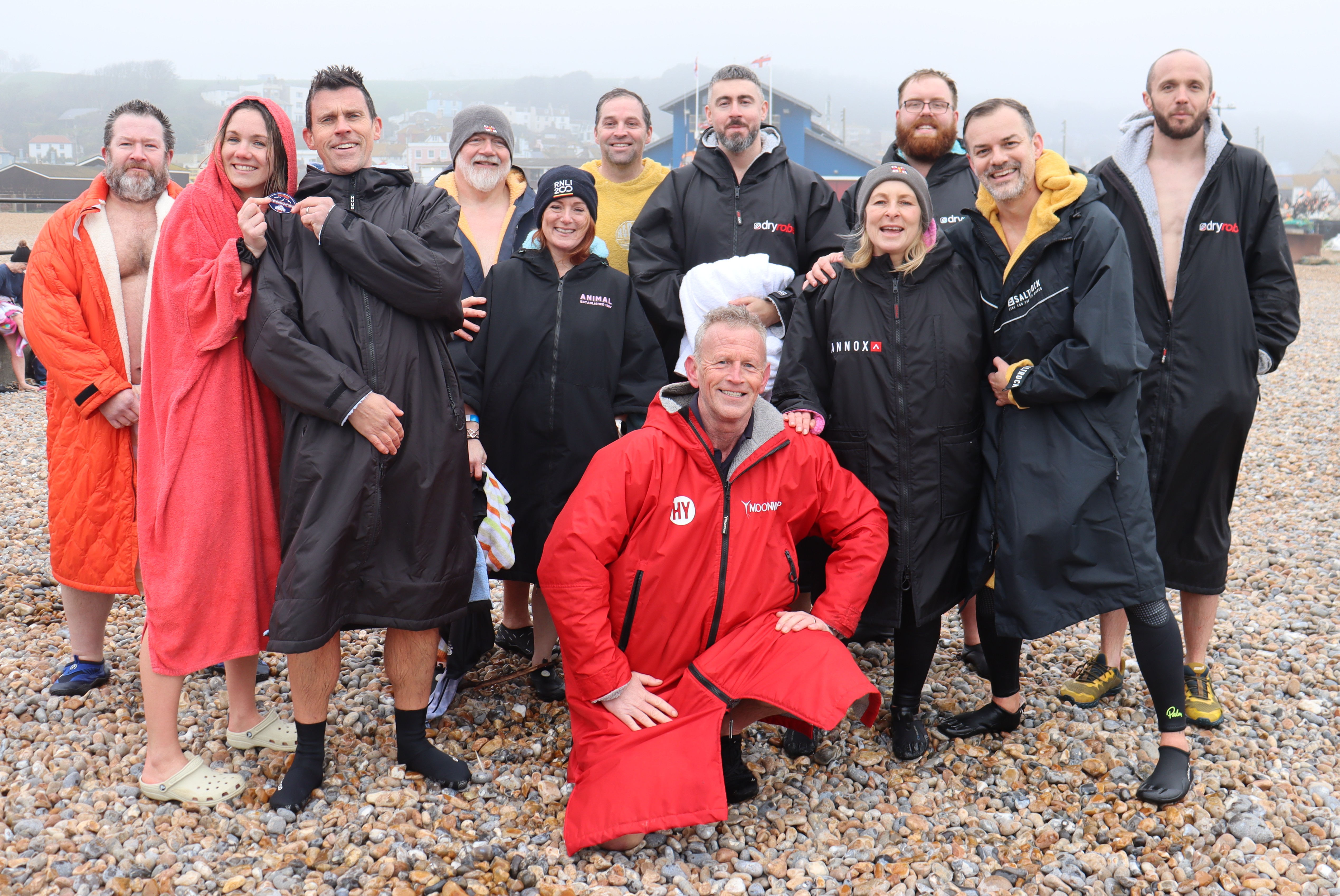 Hastings RNLI crew after their dip, in front of Hastings RNLI lifeboat station