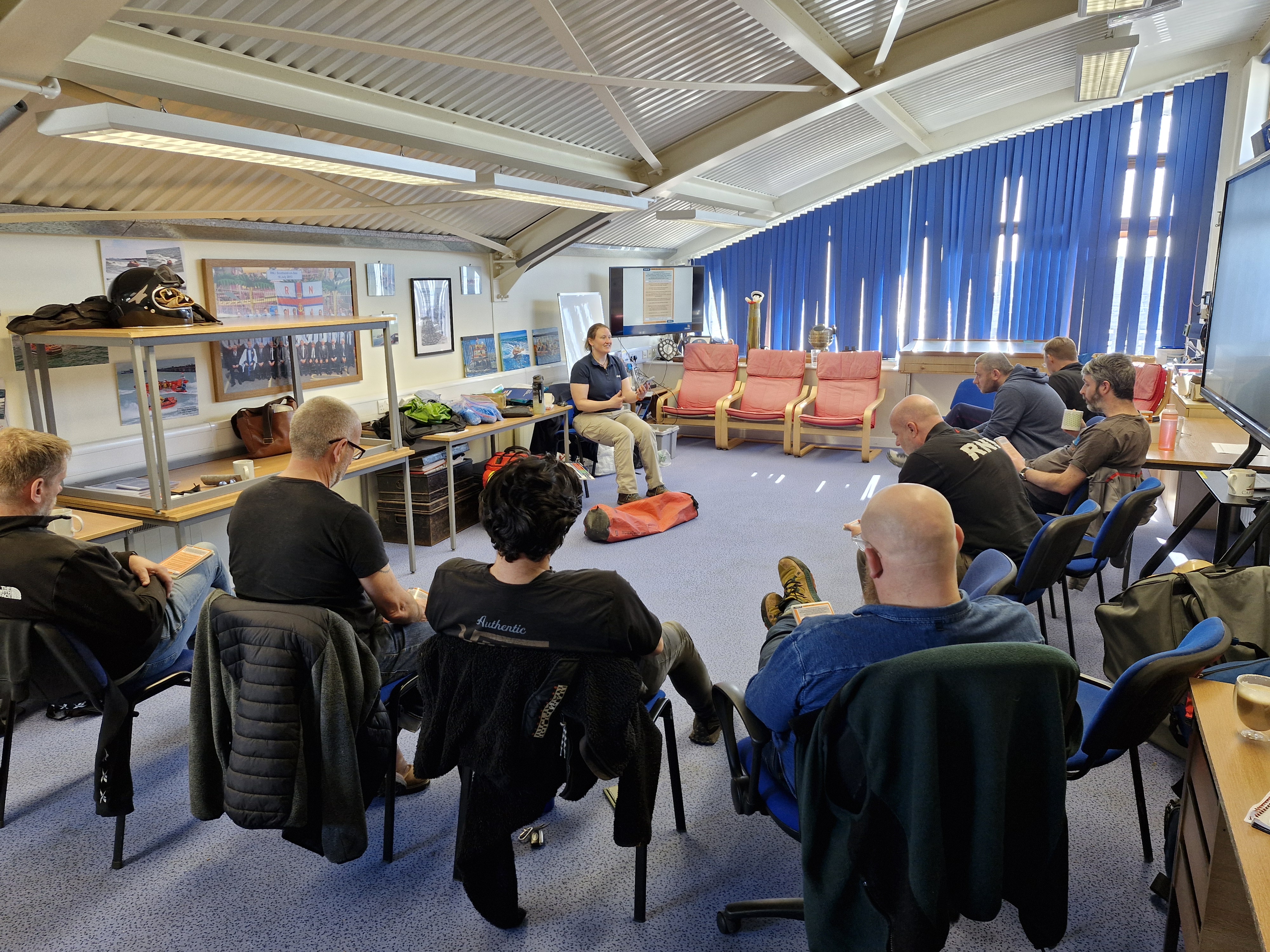 RNLI trainer Rosie covering theory and check cards in the crew room