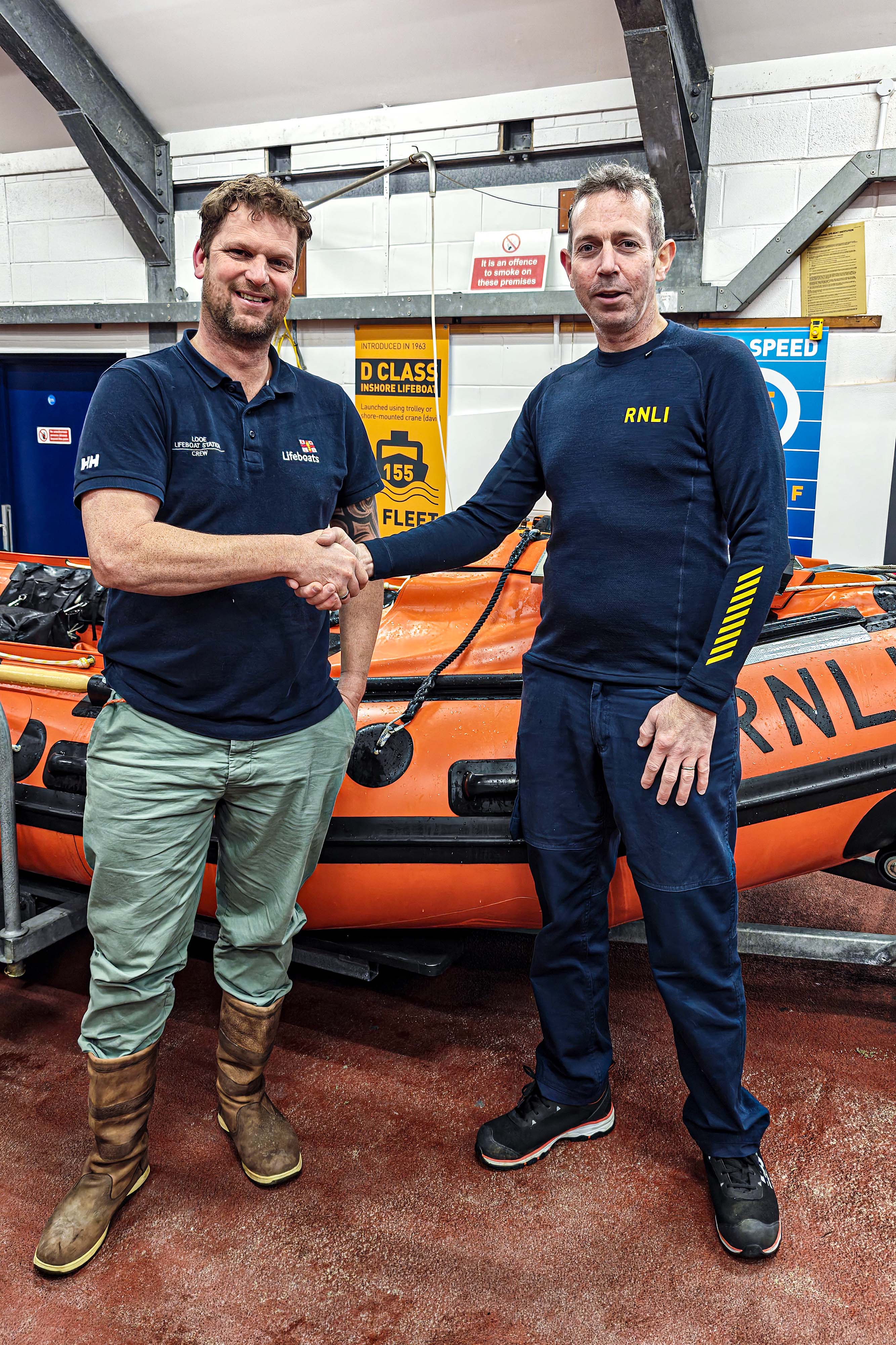 RNLI assessor / trainer Ollie George (right) congratulating Rich Jones (left) by the D Class ILB Ollie Naismith II