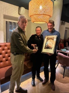 Joanne is presented with her medal and photograph from Kyle and Pete