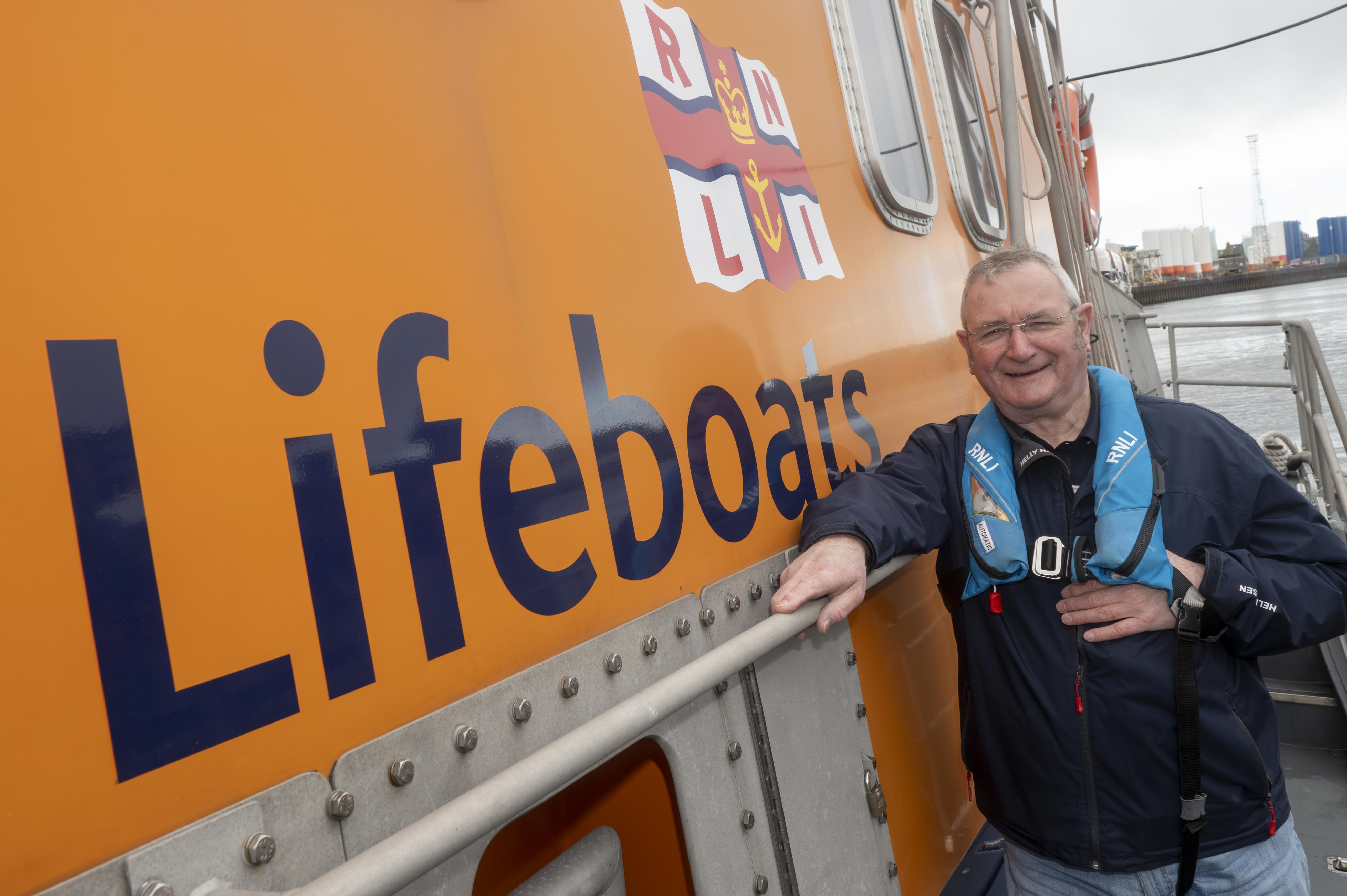 Bill Deans photographed alongside all-weather lifeboat Bon Accord