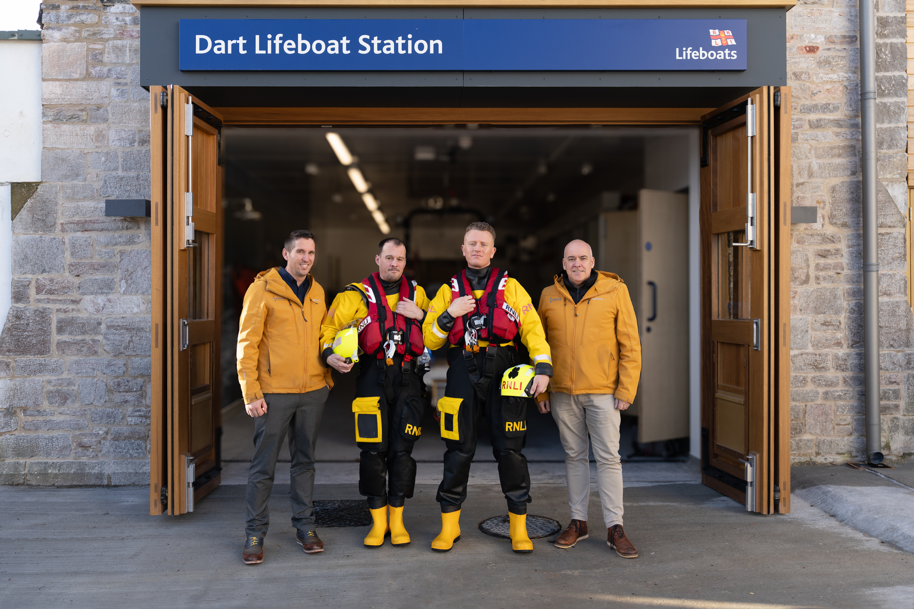 Dart RNLI volunteers stood in front of new lifeboat station