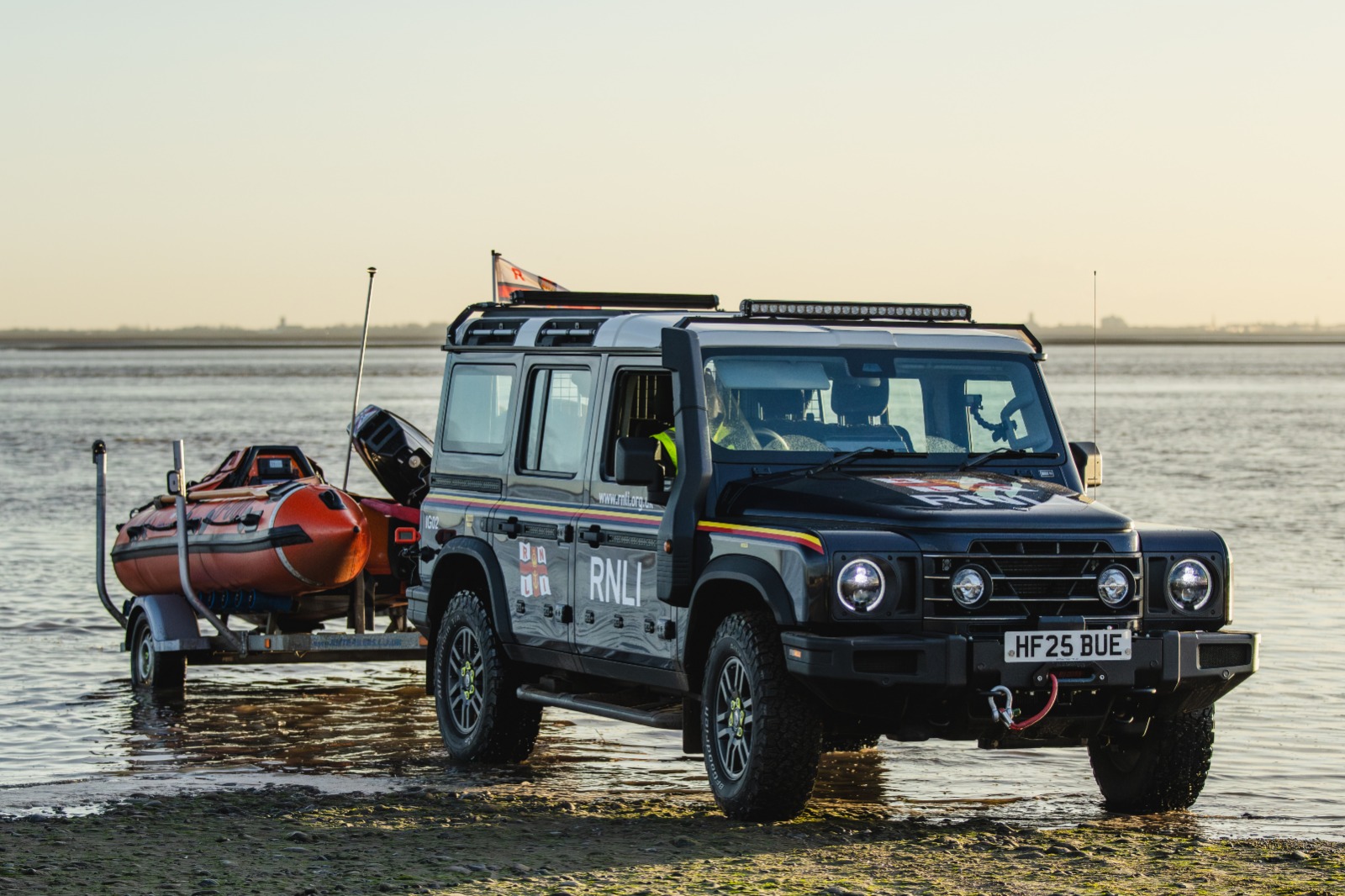 An INEOS Grenadier with a D class lifeboat behind