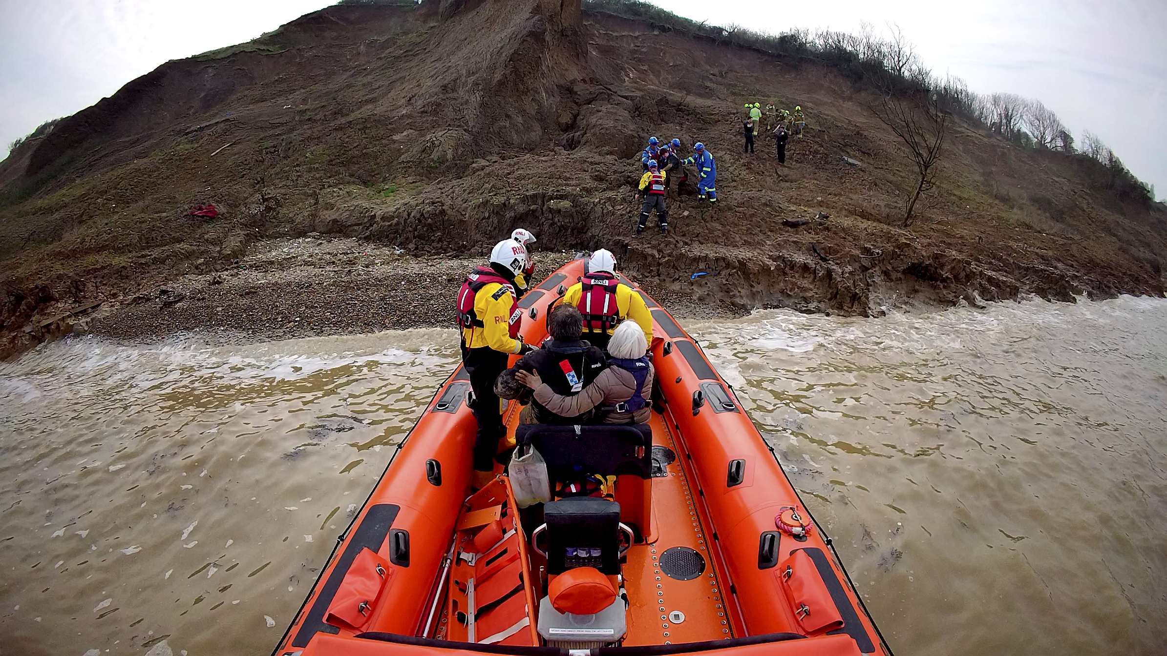 The casualties are transferred to the Whitstable lifeboat during the mud rescue on the cliffs at Warden Bay, Isle of Sheppey on Sunday afternoon.