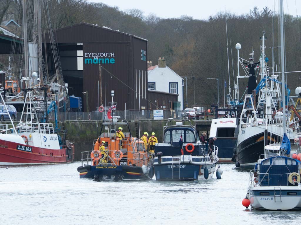 Eyemouth RNLI crew tow a motor cruiser that had suffered engine failure NE of St Abbs Head. Pictured is the lifeboat towing the casualty vessel alongside it into Eyemouth harbour.