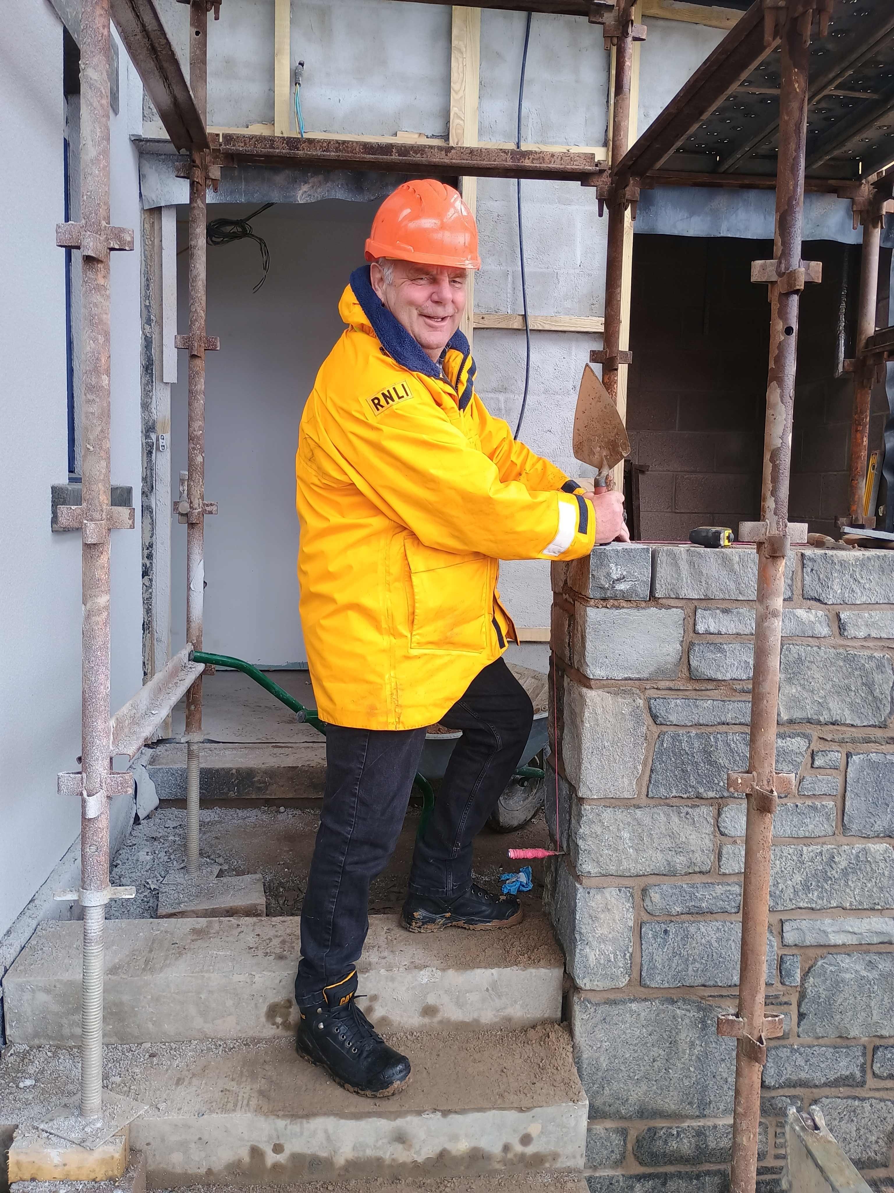 Kirkcudbright volunteer Lifeboat Operations Manager John Collins lays final stone