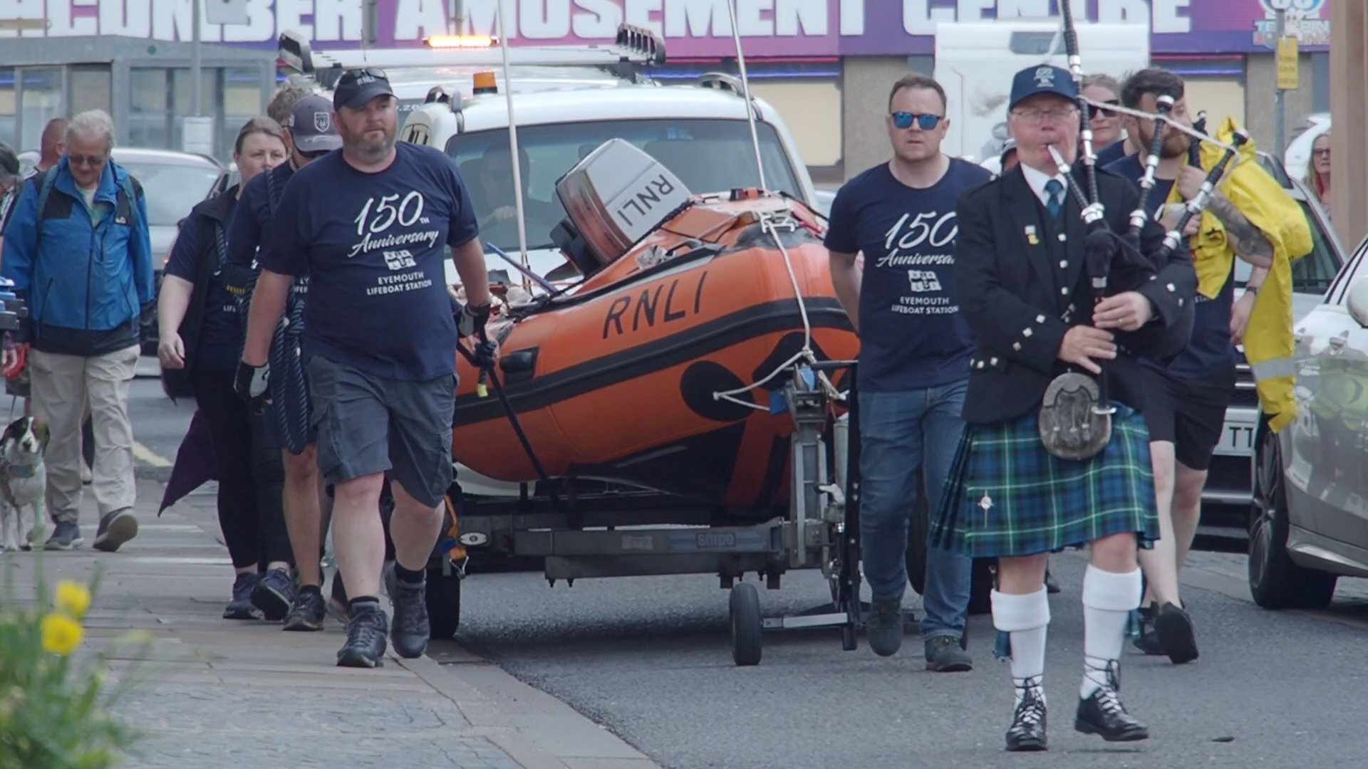 Eyemouth RNLI volunteers pull their inshore lifebat through the streets of Eyemouth to celebrate the 150th anniversary of the station