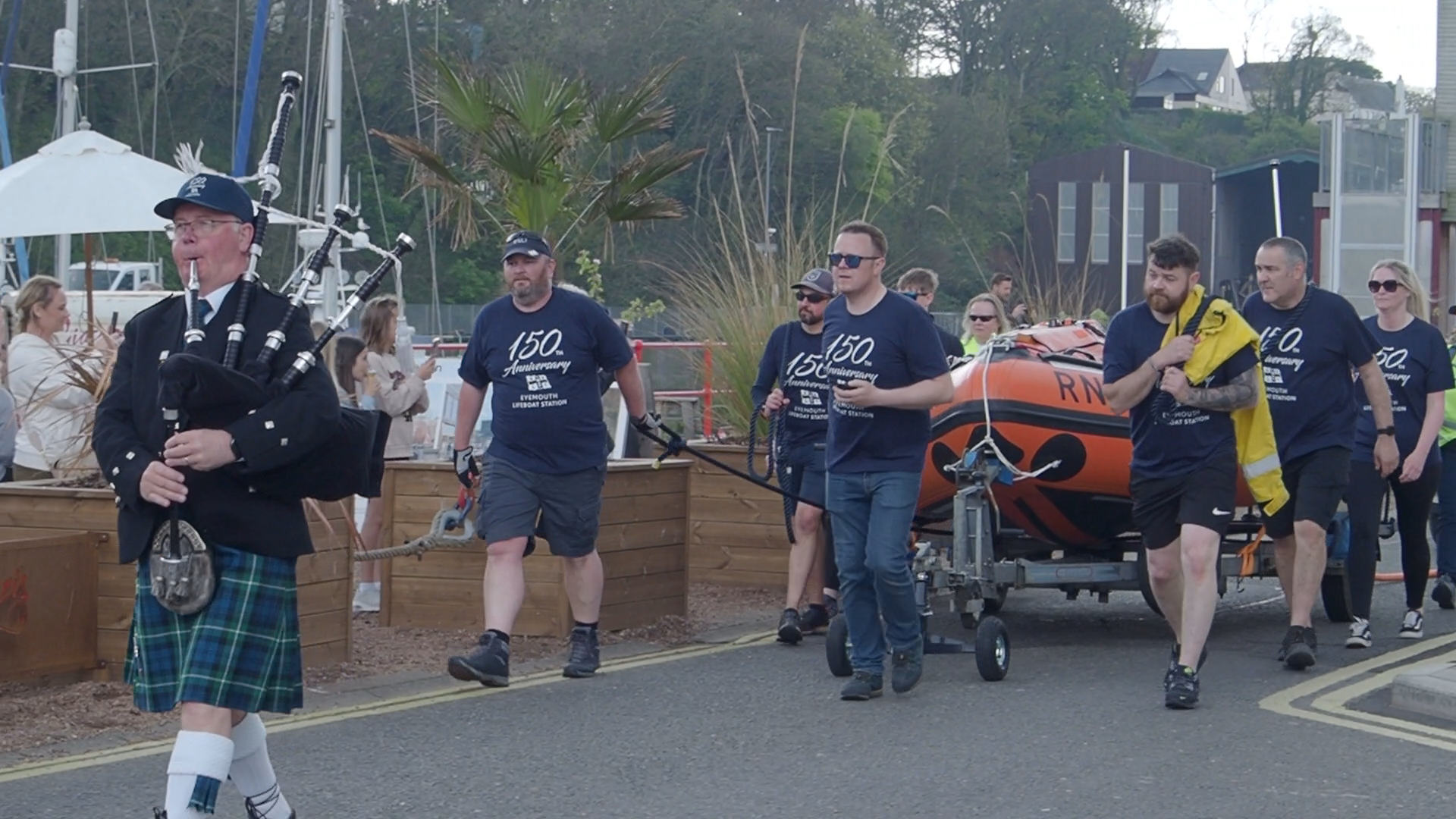 Eyemouth RNLI volunteers pull their inshore lifeboat alongside Eyemouth harbour to celebrate the 150th anniversary of the station