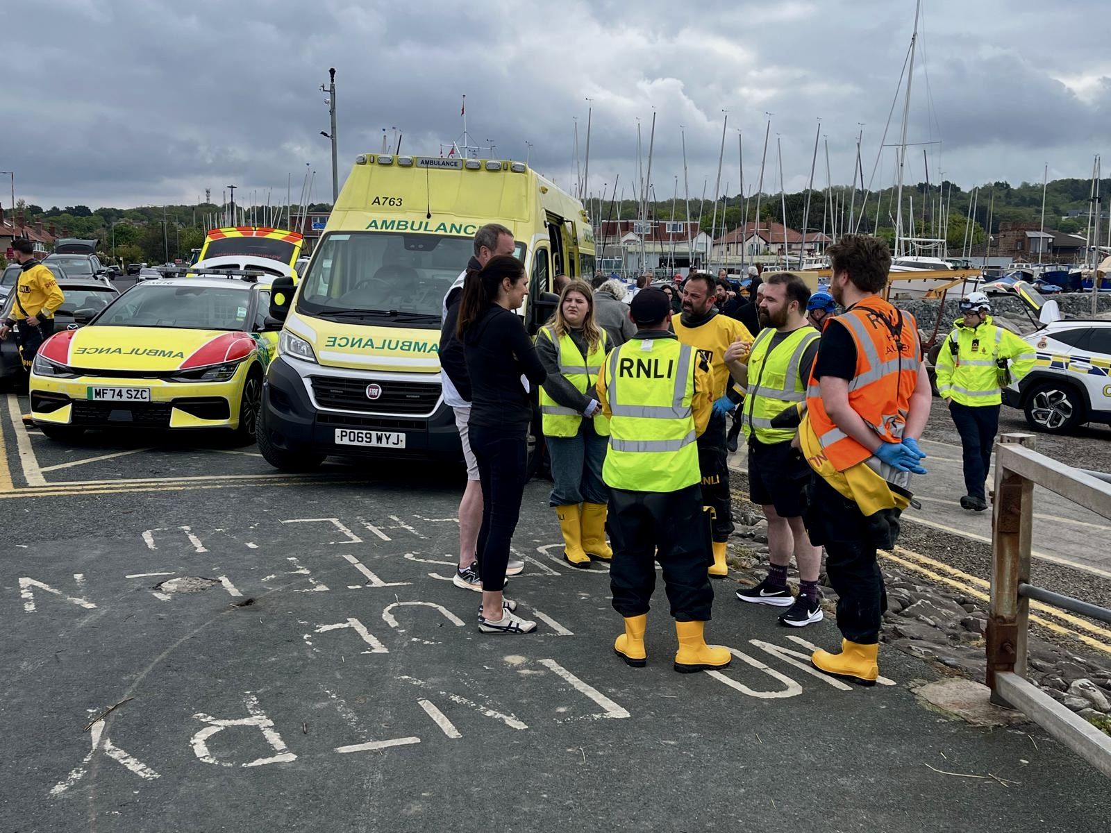 The crew debrief in front of emergency vehicles 