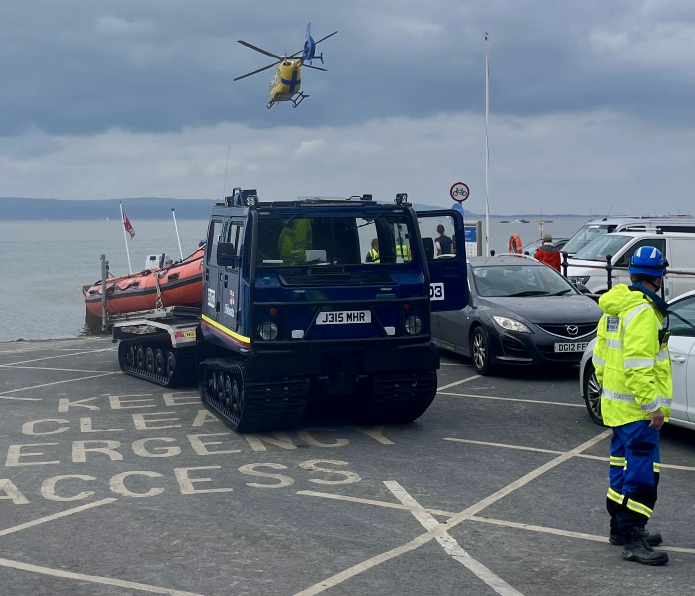 The air ambulance can be seen overhead the launch vehicle and lifeboat 