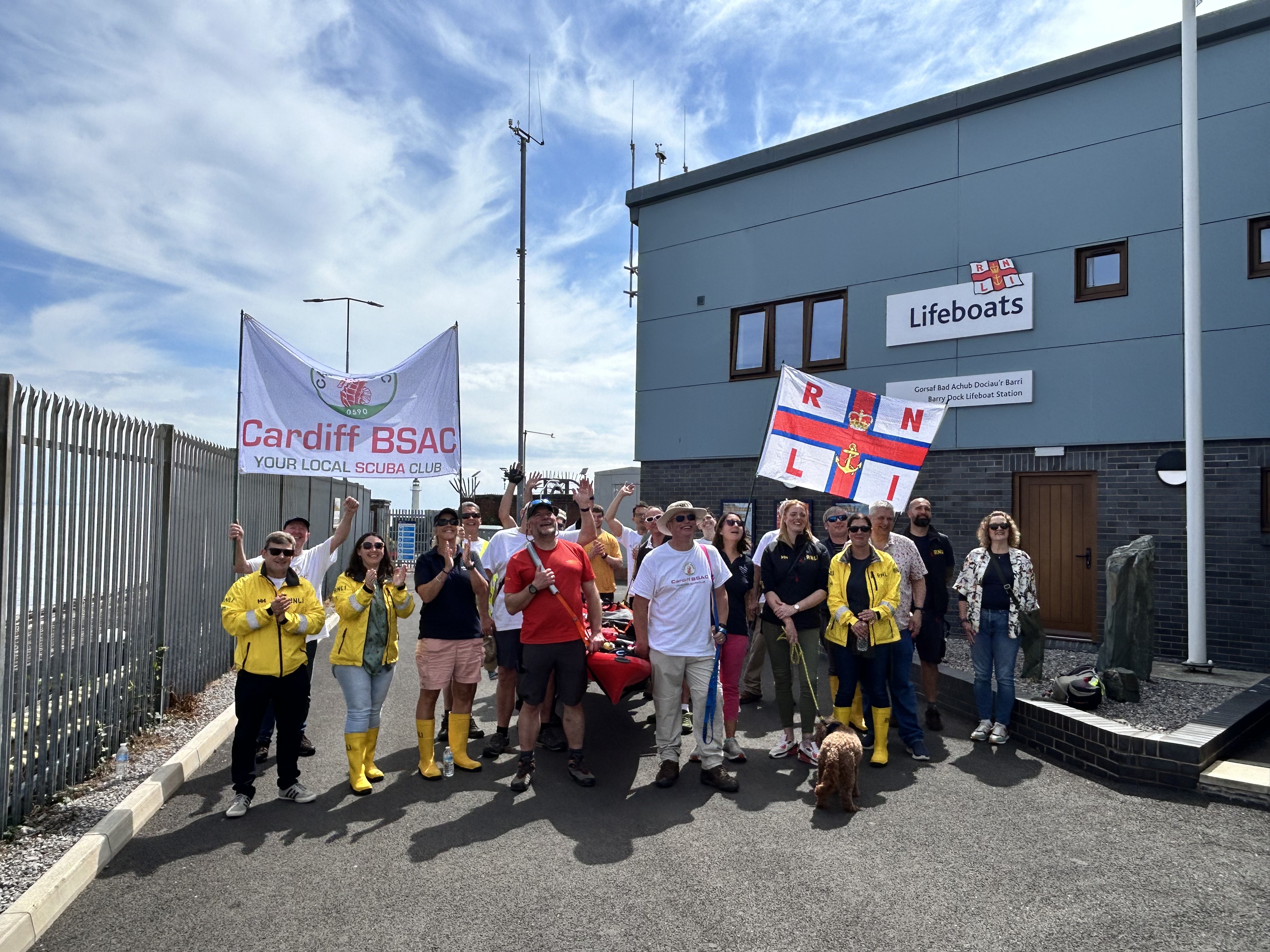 A group of smiling walkers in from of Barry Dock's lifeboat station