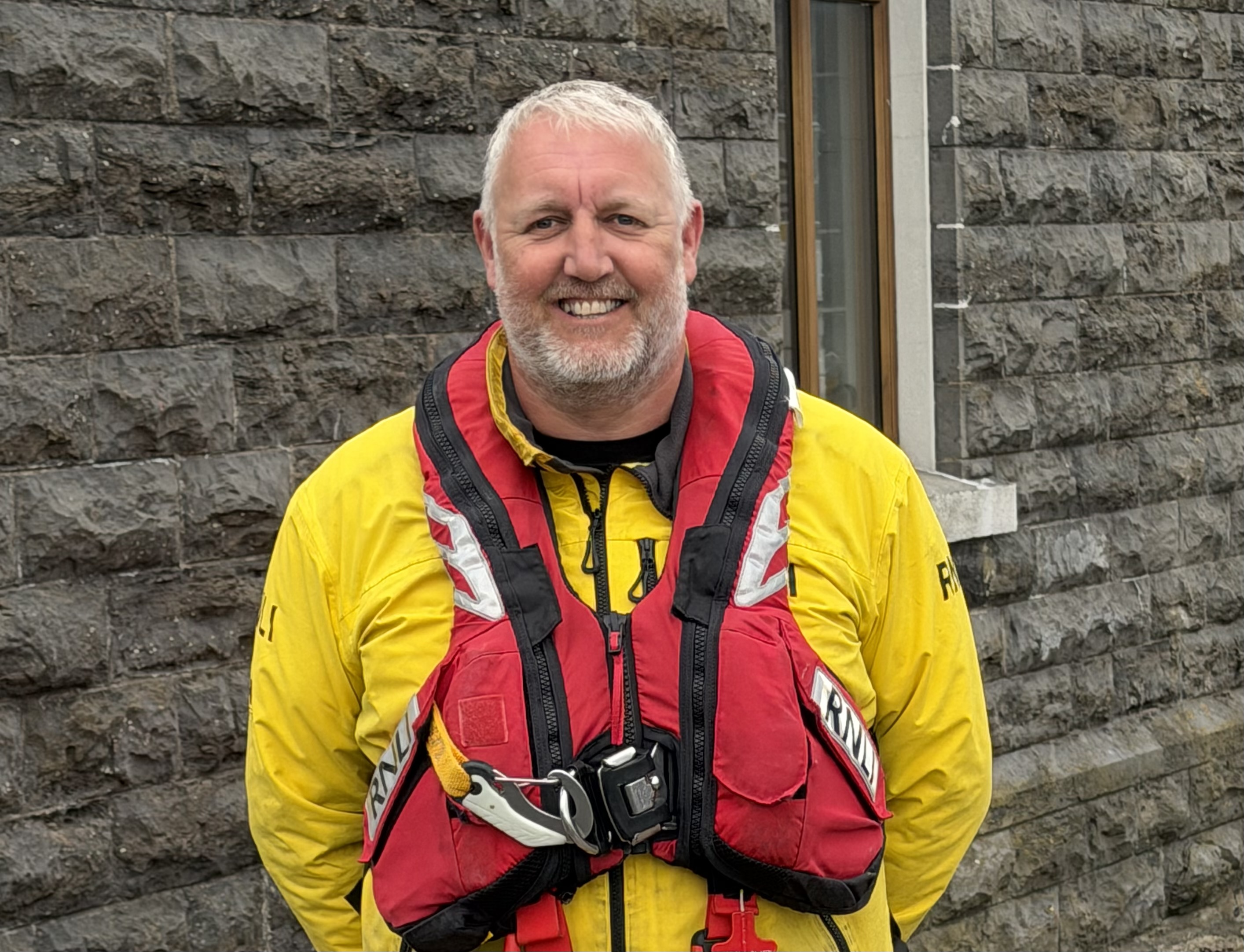Photograph is of Rob Marshall in his lifeboat jacket and lifejacket. Taken outside Port St Mary RNLI station
