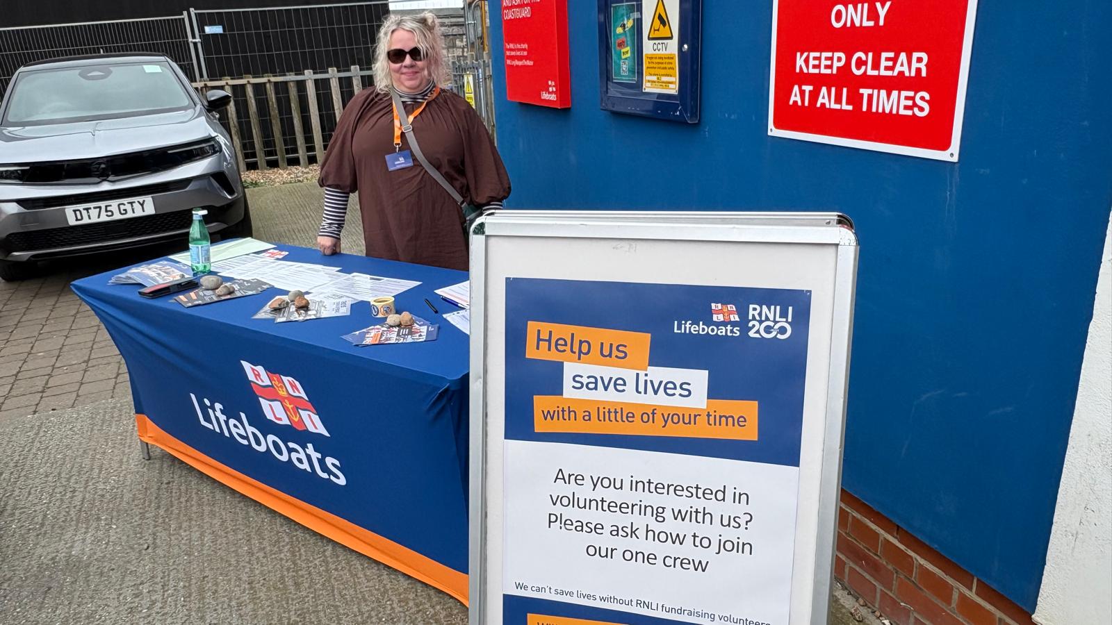Volunteer at a recruitment desk