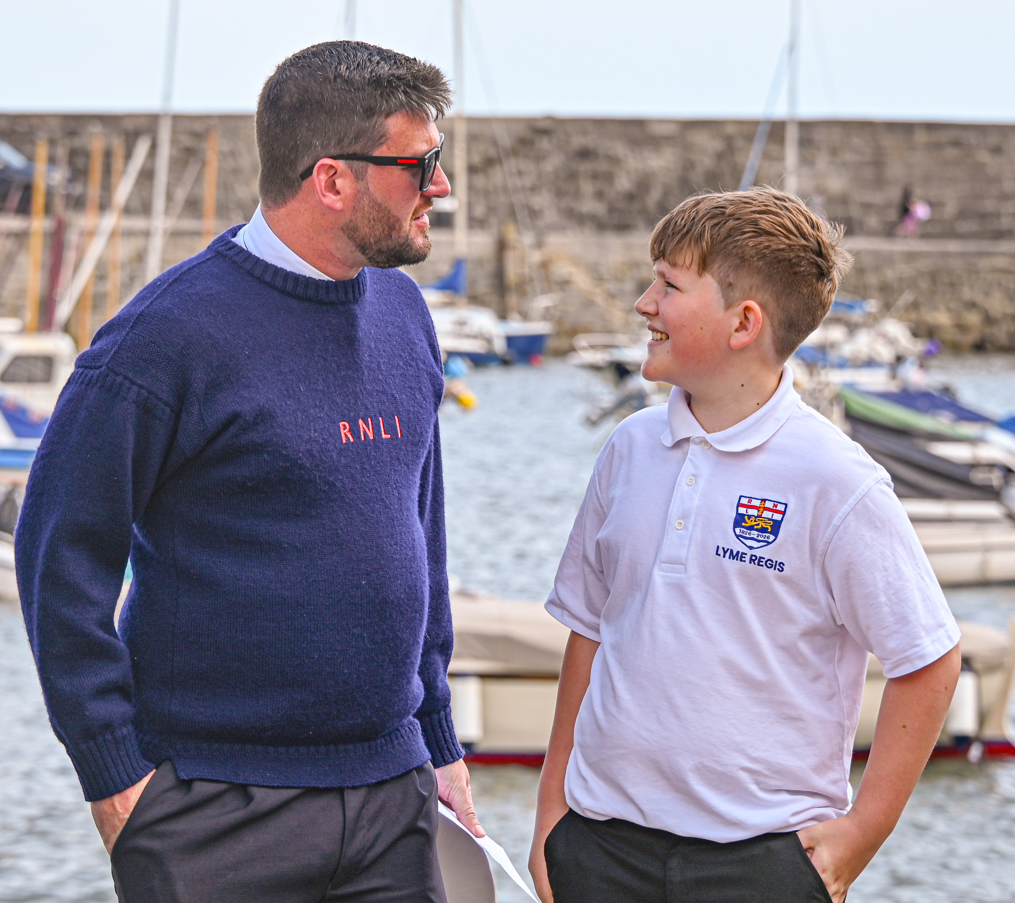 Father in blue jumper with son in white top