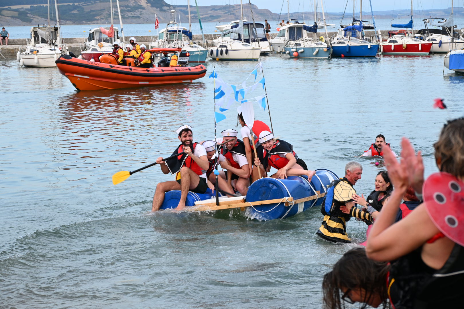 raft on the water with lifeboat in the background
