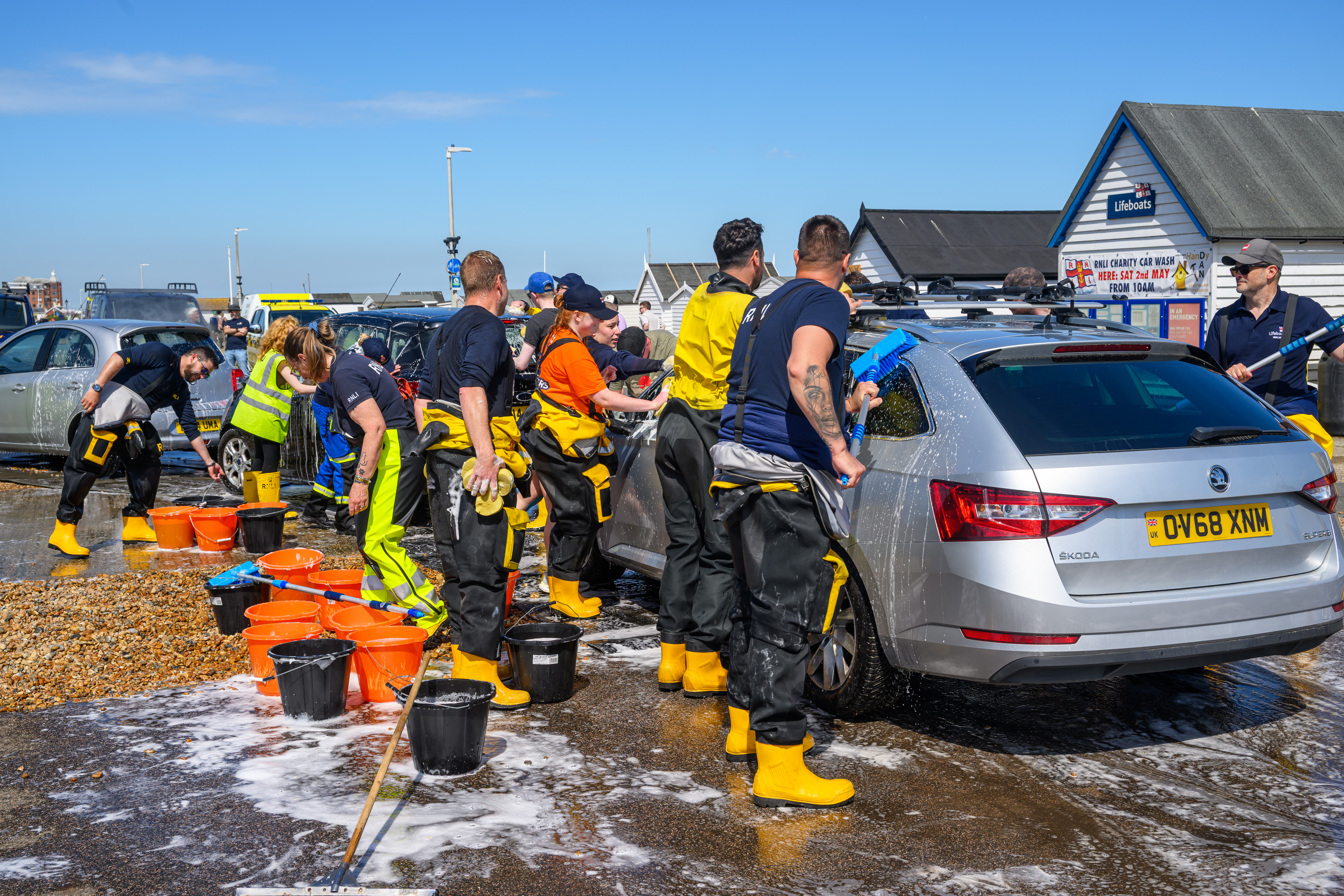 Volunteers at work washing cars.