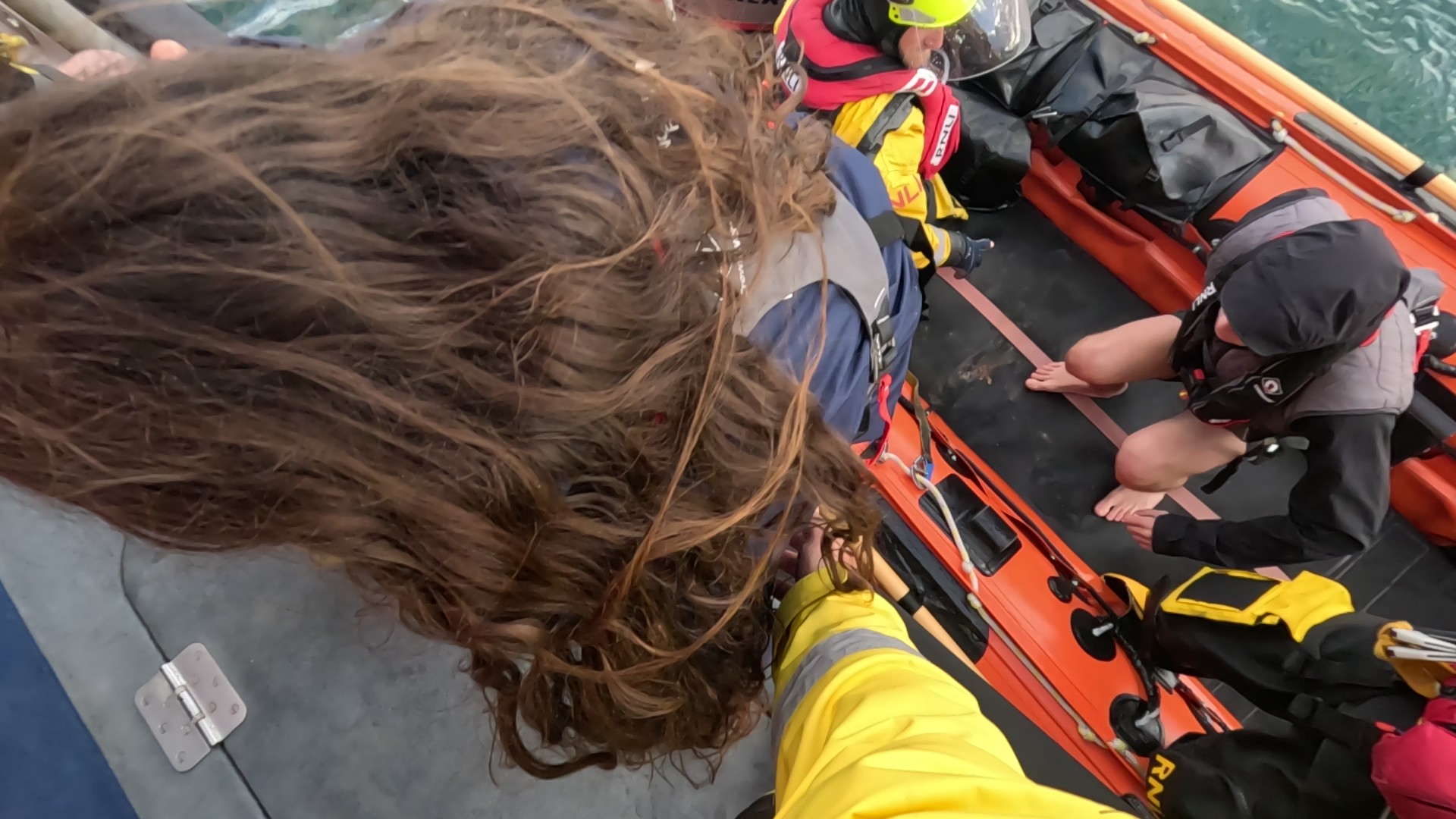 Casualties being brought onto Torbay's All-Weather lifeboat by the volunteer crew