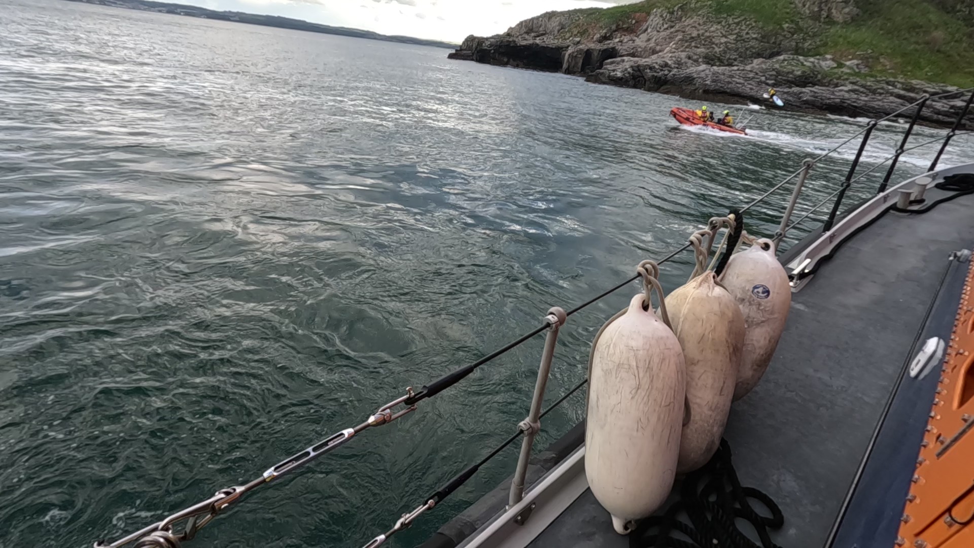 Torbay's D-class Inshore lifeboat approaching the All-Weather lifeboat
