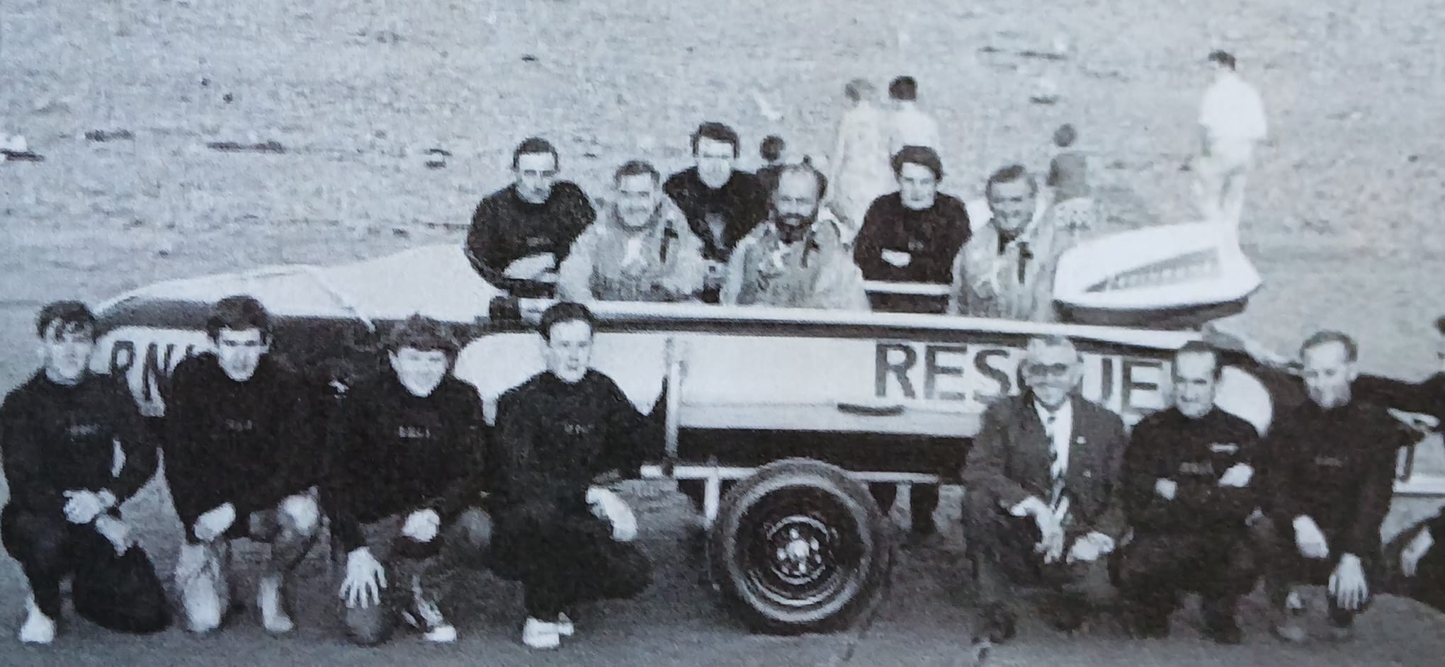 Landscape image in black and white of the first RNLI lifeboat and it's crew members