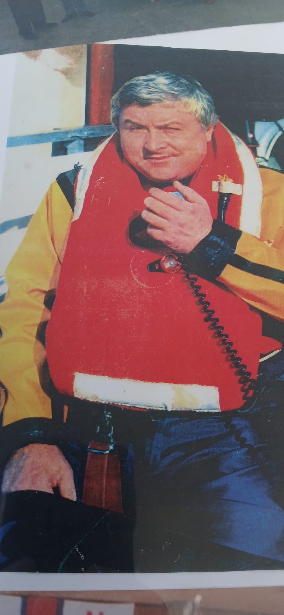 Portrait image of Ron in uniform on the lifeboat many years ago