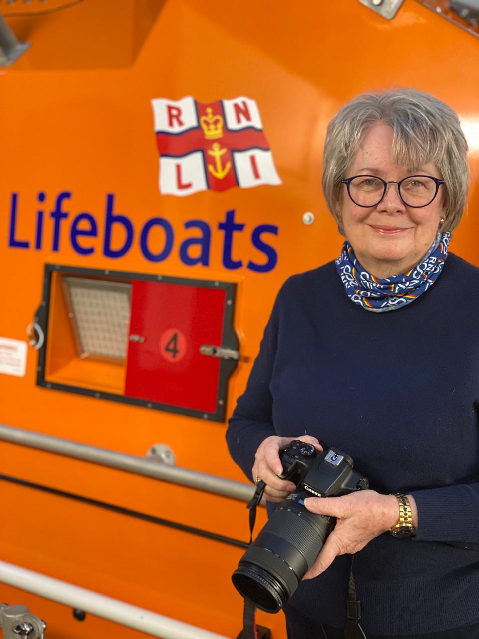 Carol stood holder her camera infront of the all-weather lifeboat