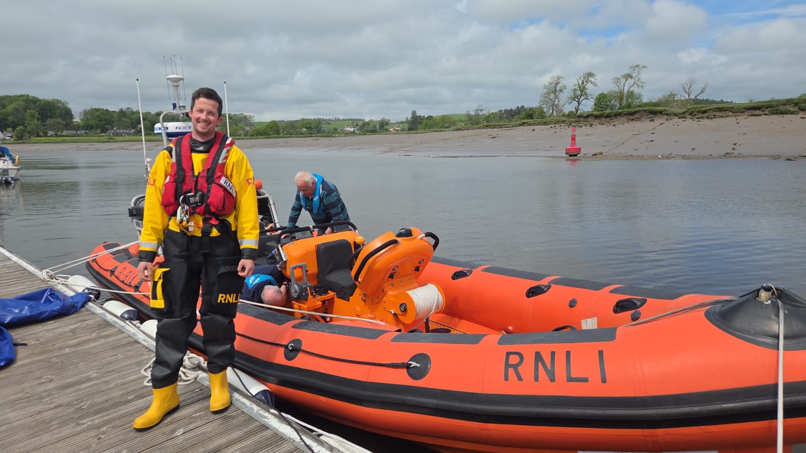 Tom beside the Sheila Stenhouse on his return with the boat's mechanic in the background