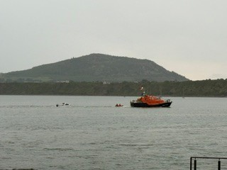 Two casualty crafts being towed into Porthdinllaen Harbour