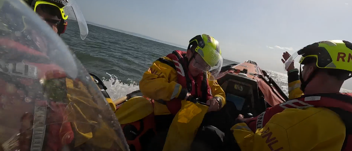 Barry Dock RNLI volunteer crew assess the situation after recovering the casualties from the water during the rescue off Aberthaw. Credit: RNLI/Barry Dock