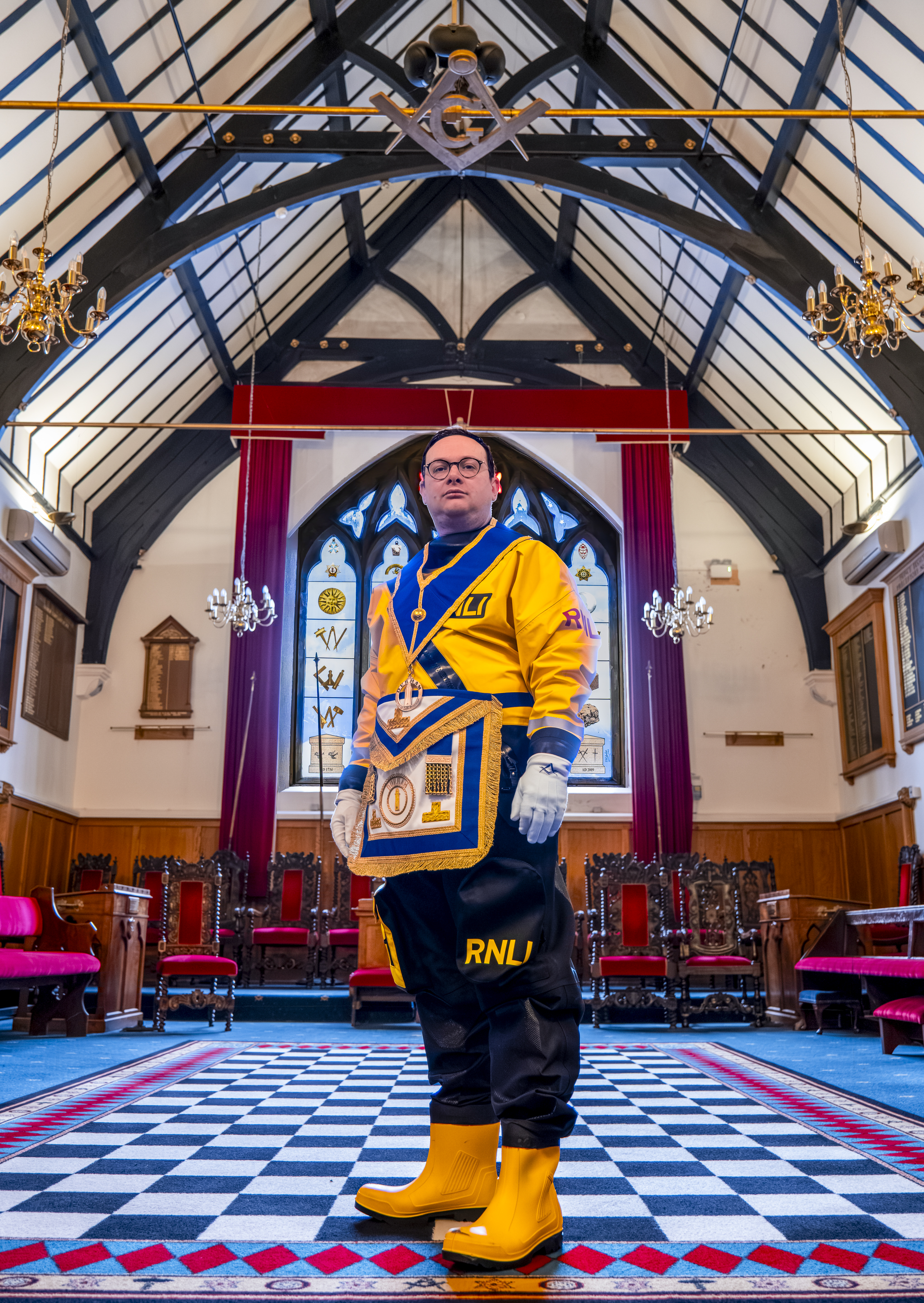 Lloyd in both his RNLI dry suit and some of his Freemason regalia, showing dual identity
