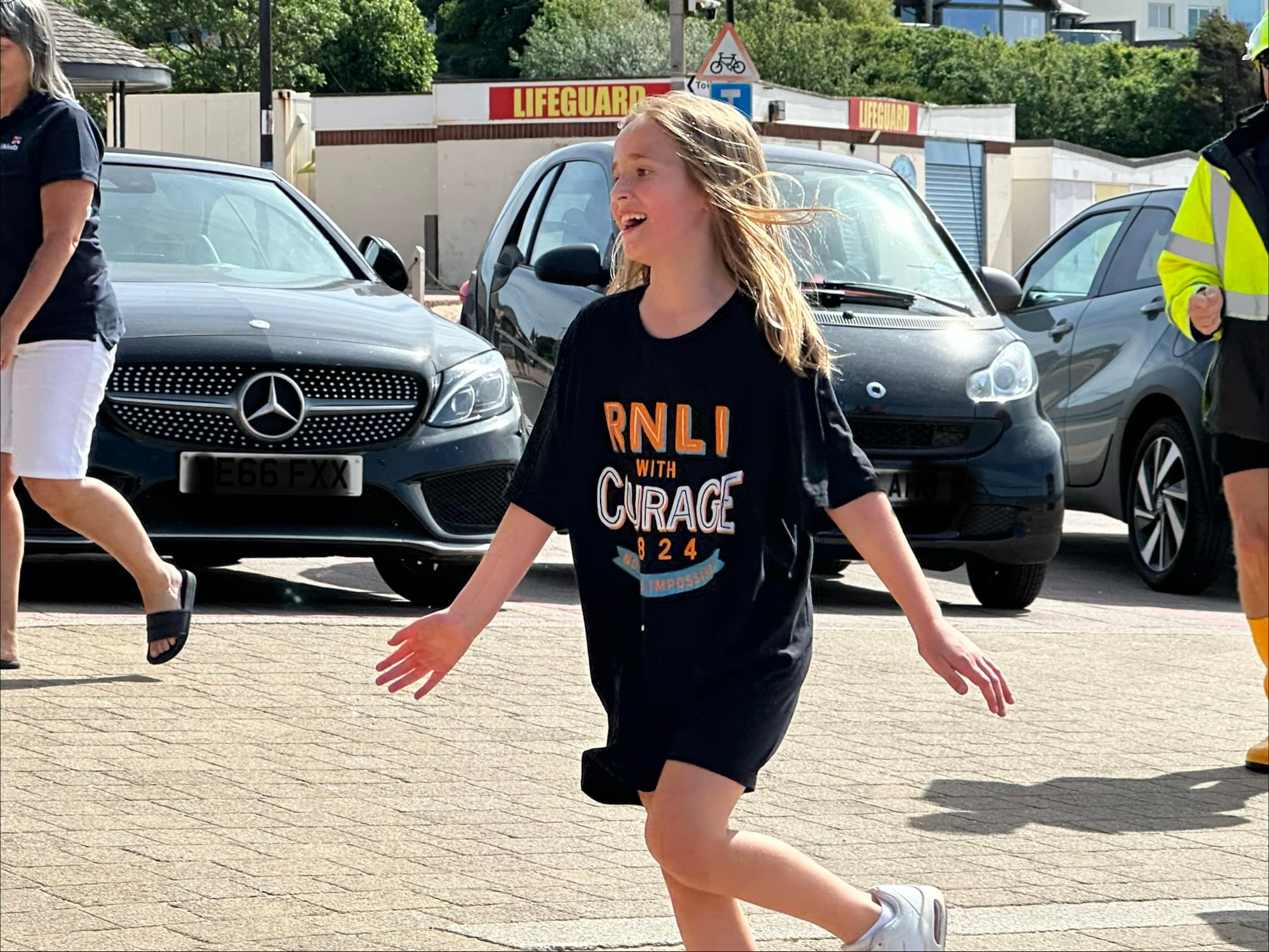 Ivie Simkiss-Cowtan finishing her Mayday Mile at Exmouth RNLI lifeboat station