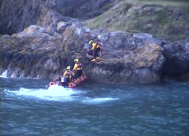 ILB crew at the shoreline at dawn about to transfer the first casualty onto the ILB