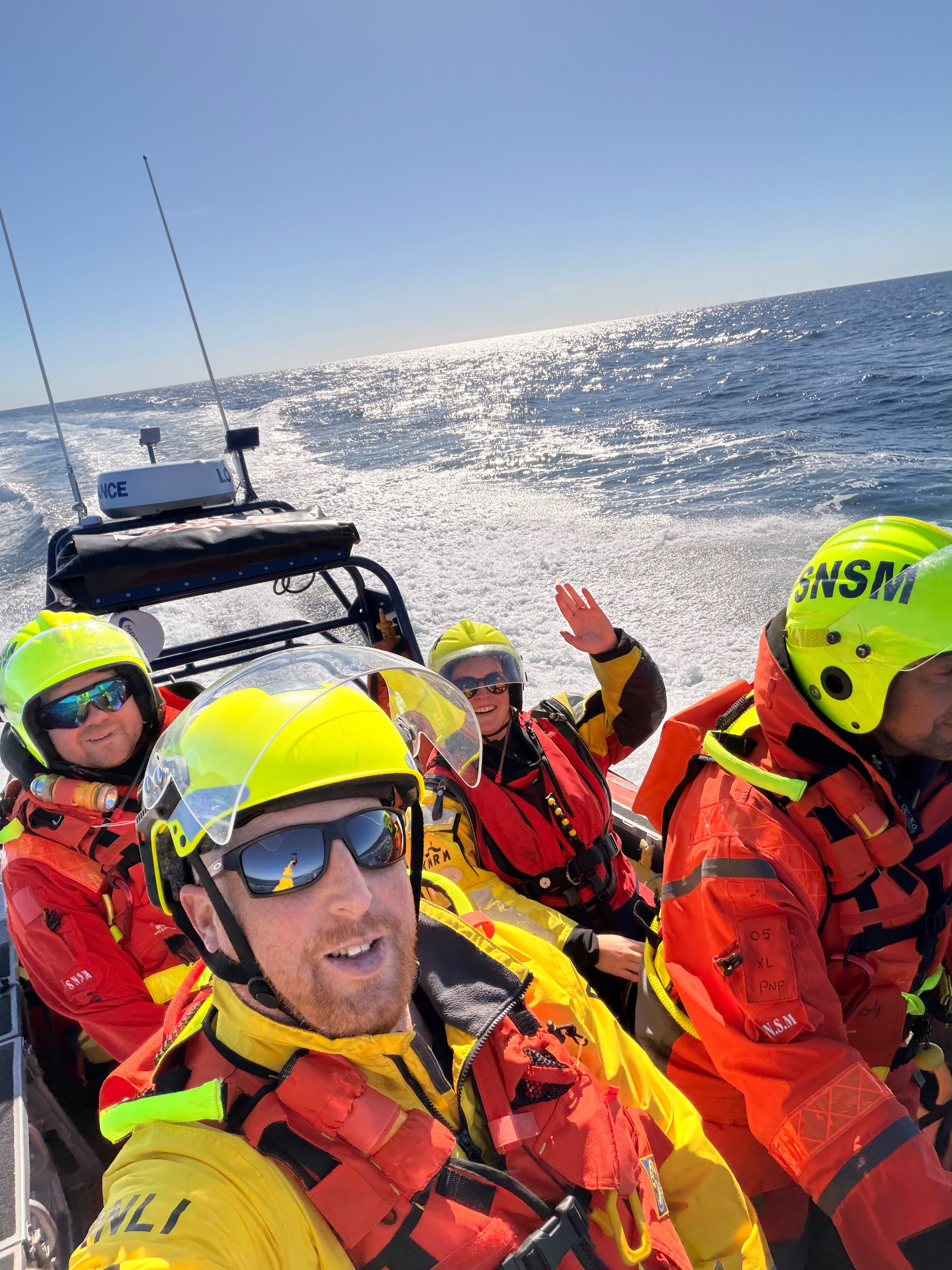 Four people in a lifeboat.