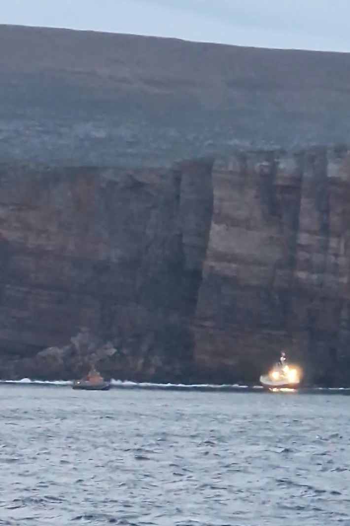 Casualty is brightly lit with lifeboat standing by to the left