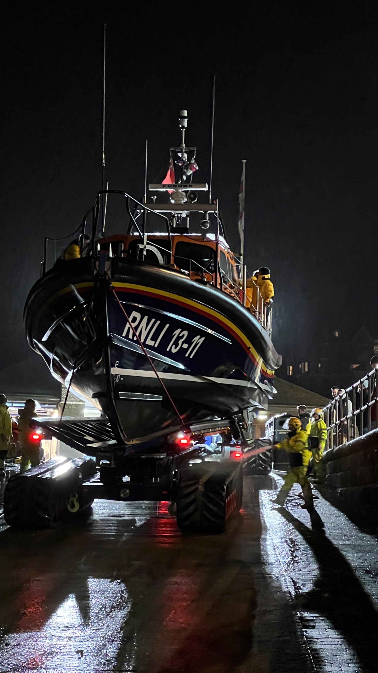 All-weather lifeboat being washed down by volunteer crew on the slipway