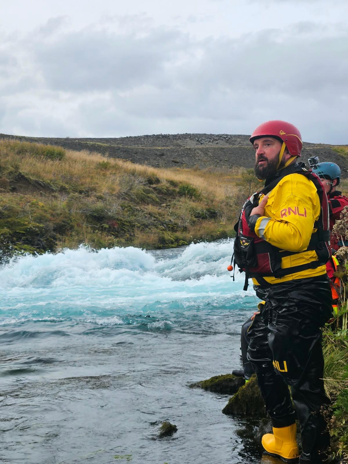 Gordon stood next to a River about to conduct swift water rescue 