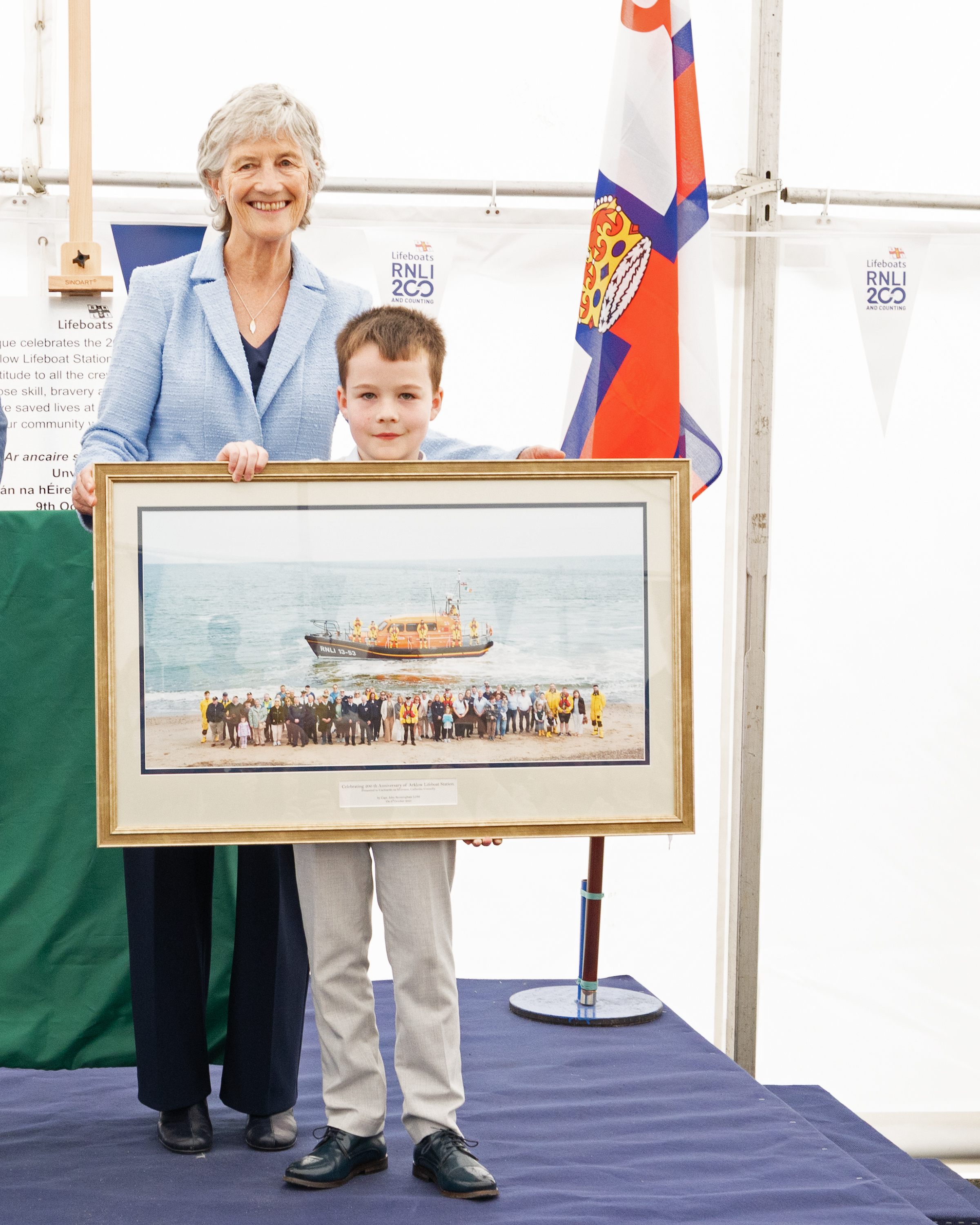 President Catherine Connolly is presented with a photograph of Arklow RNLI by Eoin Russell