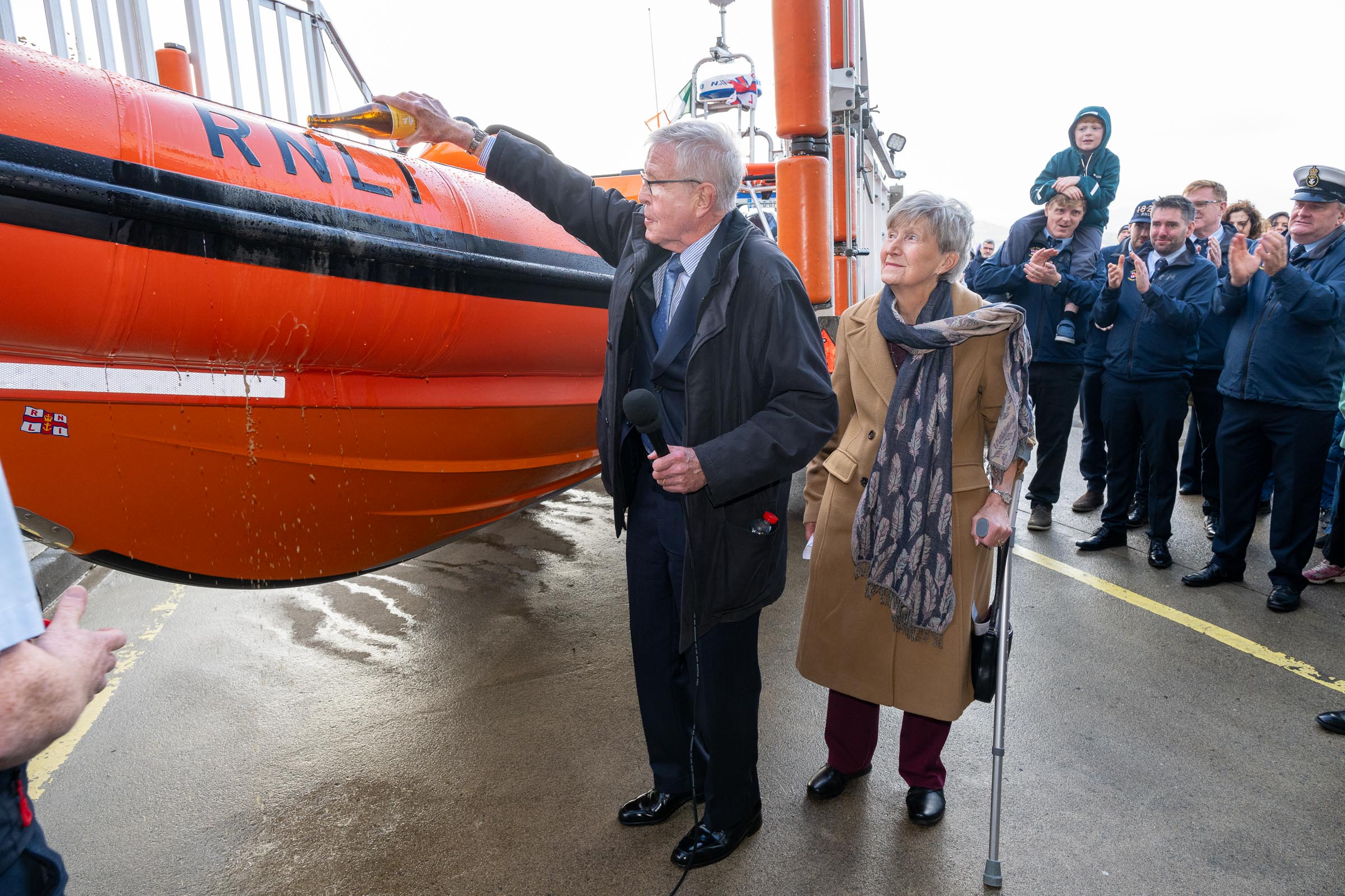 Richard and Jennifer Kendrick naming the lifeboat while pouring local craft beer Kinnegar over the side