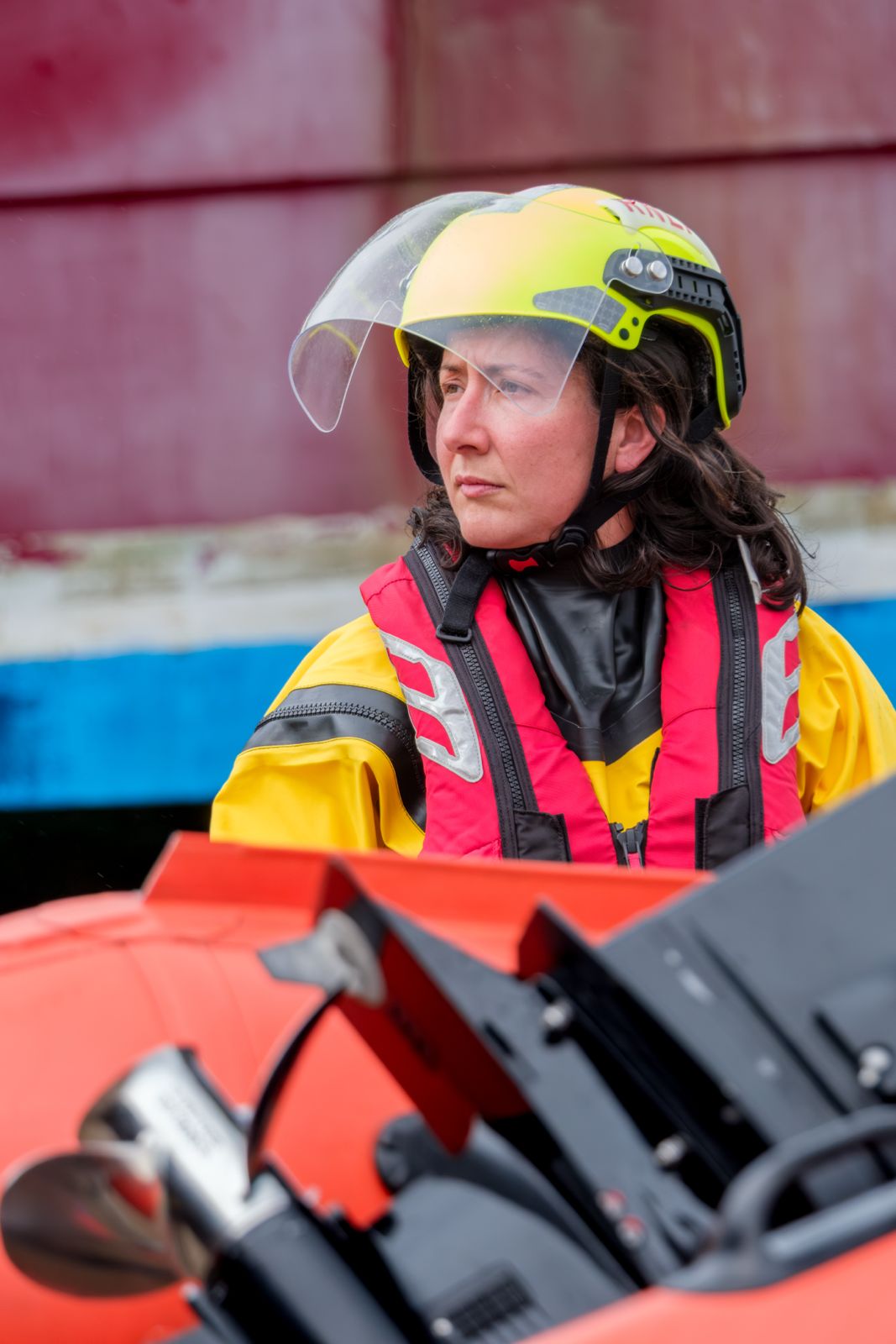 An RNLI Volunteer in kit waiting to board D-Class Lifeboat.