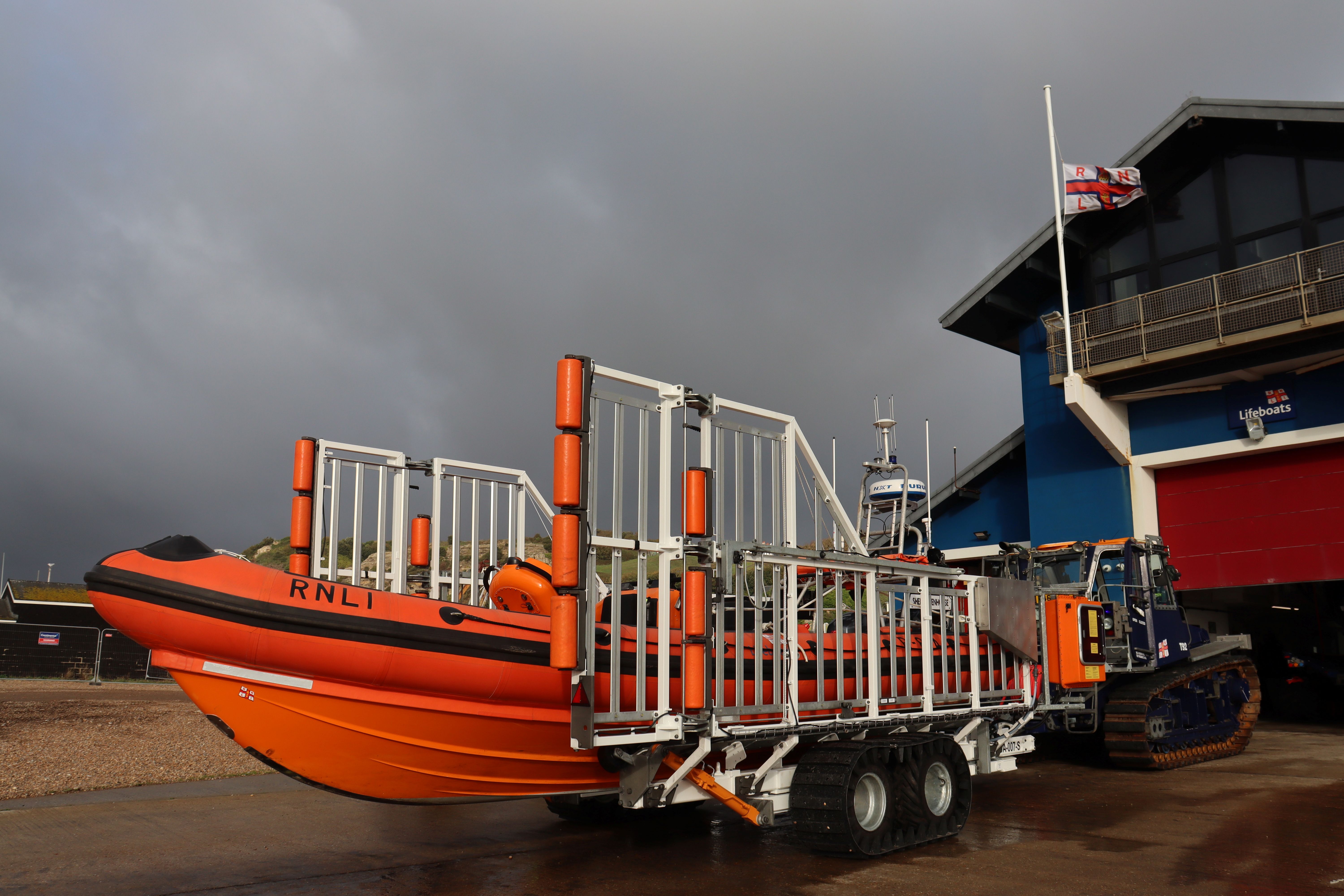 A85 lifeboat outside Hastings lifeboat station with a broody sky in the background