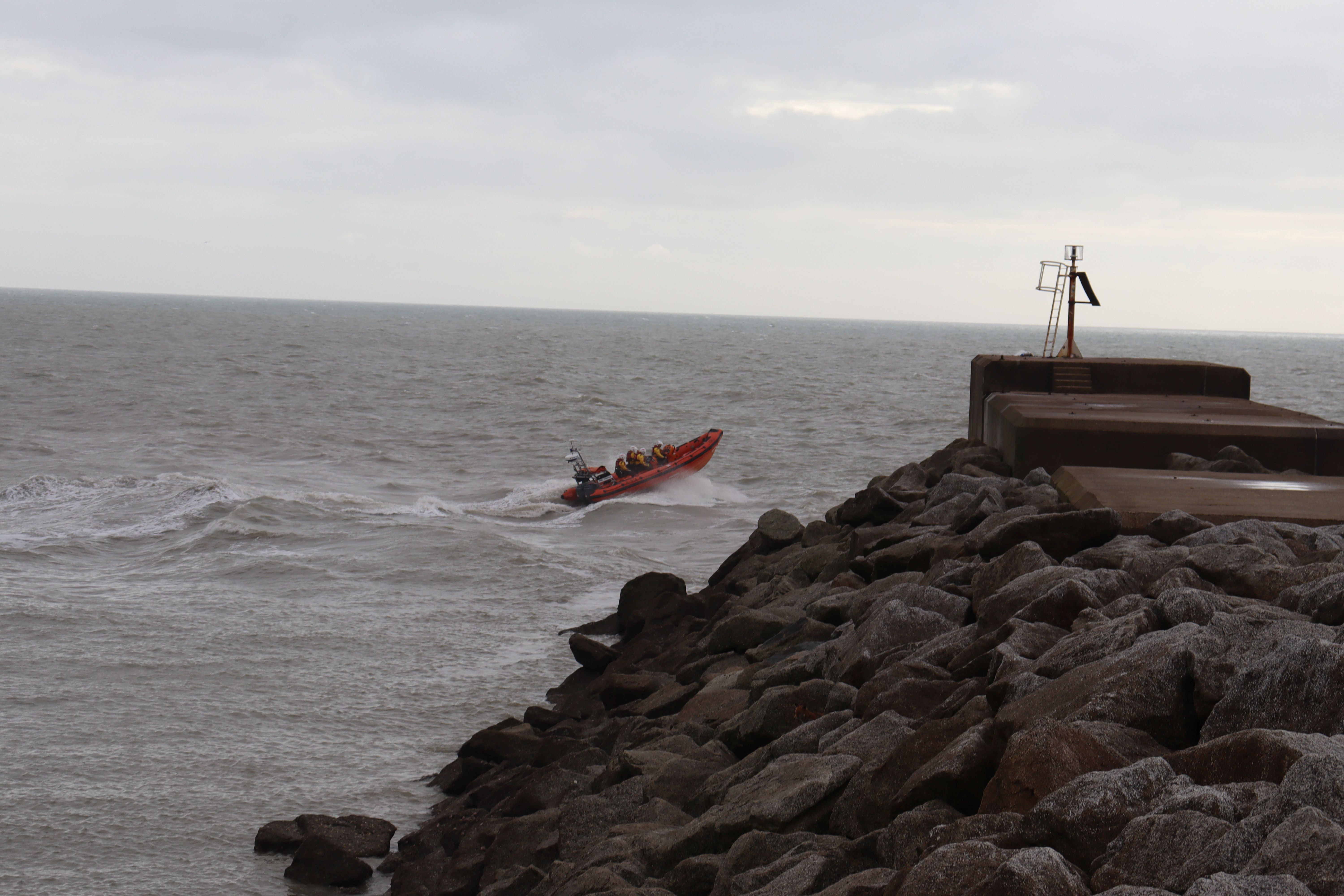 The A85 boat is seen at an angle as it passes the end of the harbour arm