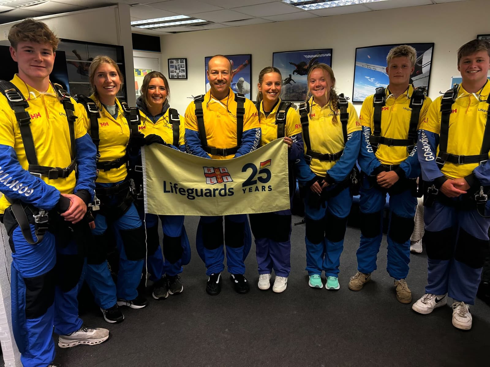 Landscape image of RNLI lifeguards in their skydive kit
