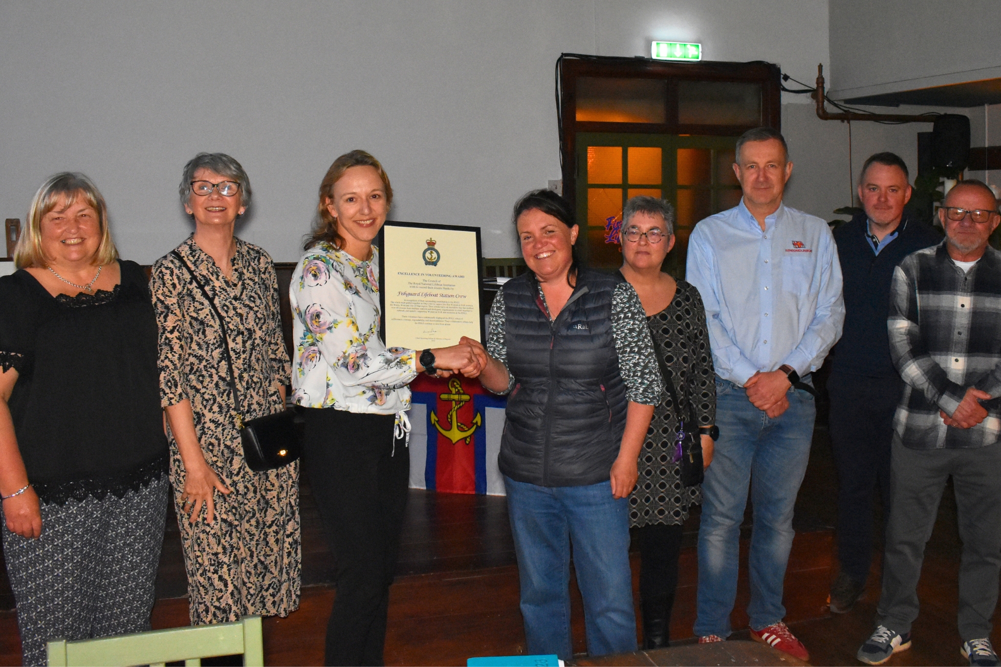 Area Operations Manager presents the Excellence in Volunteering award to some of the Fishguard crew who made the event a success.
